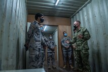 U.S. Coast Guard Lt. j.g. Miles Miller, right, assigned to Coast Guard Patrol Forces Southwest Asia (PATFORSWA), shows facilities used for visit, board, search and seizure (VBSS) training to Saudi Arabian Border Guard Capt. Ali bin Madi Al-Qahtani, left, commander of Combined Task Force (CTF) 152, during a visit to the Coast Guard Maritime Engagement Team training facility on board Naval Support Activity Bahrain, Sept. 10. PATFORSWA is comprised of the Maritime Engagement Team, shoreside support personnel and six 110' cutters and is the Coast Guard's largest unit outside of the U.S., playing a key role in supporting the Navy’s maritime security and maritime infrastructure protection operations in the U.S. 5th Fleet area of operations.