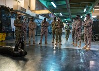 U.S. Coast Guard Maritime Law Enforcement Specialist 1st Class George Soto, left, assigned to Coast Guard Patrol Forces Southwest Asia (PATFORSWA), shows equipment used for combat and wrestling training to members of the Saudi Arabian Border Guard and Combined Task Force (CTF) 152, during a visit to the Coast Guard Maritime Engagement Team training facility on board Naval Support Activity Bahrain, Sept. 10. PATFORSWA is comprised of the Maritime Engagement Team, shoreside support personnel and six 110' cutters and is the Coast Guard's largest unit outside of the U.S., playing a key role in supporting the Navy’s maritime security and maritime infrastructure protection operations in the U.S. 5th Fleet area of operations.