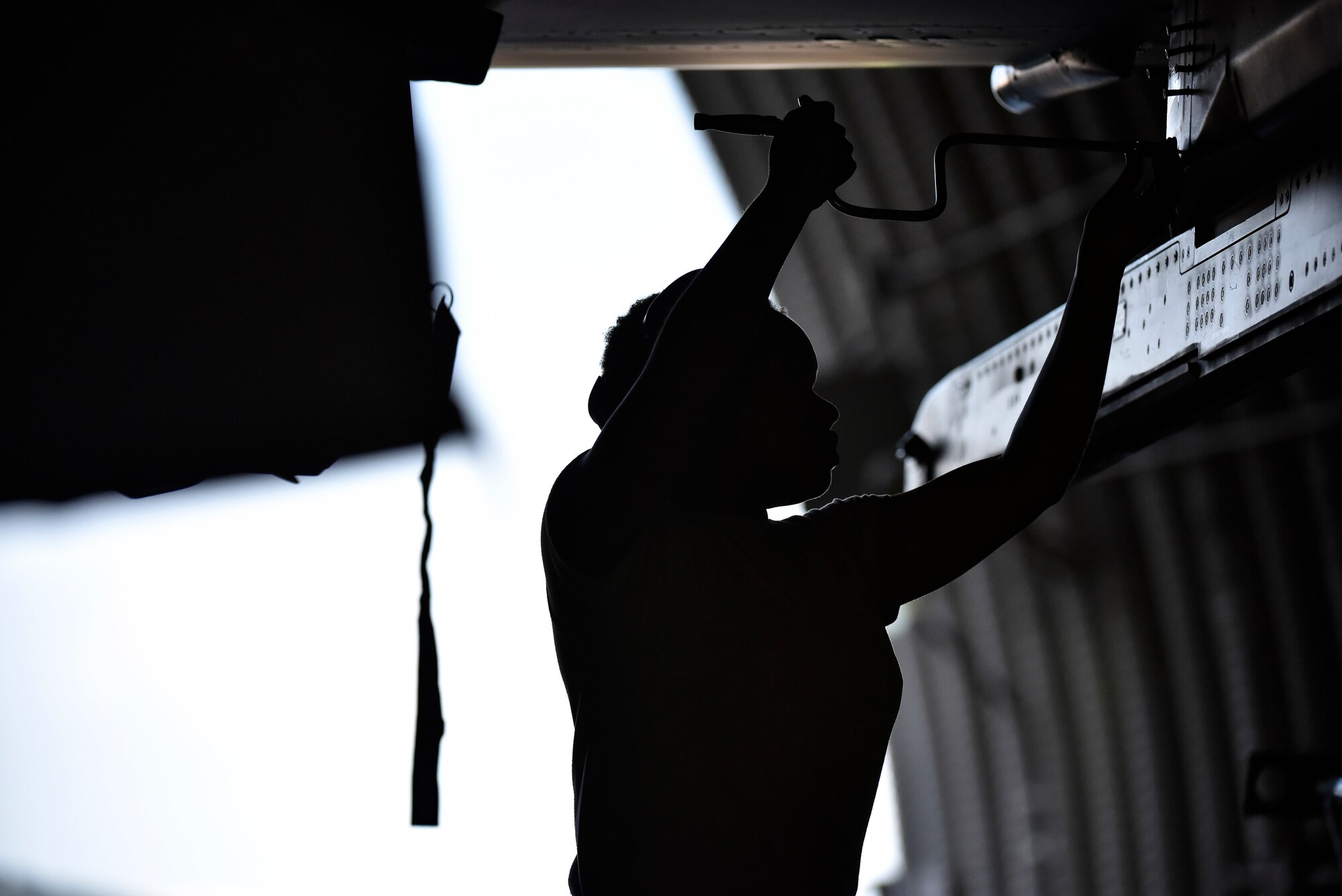 A photo of an Airman tightening a screw.