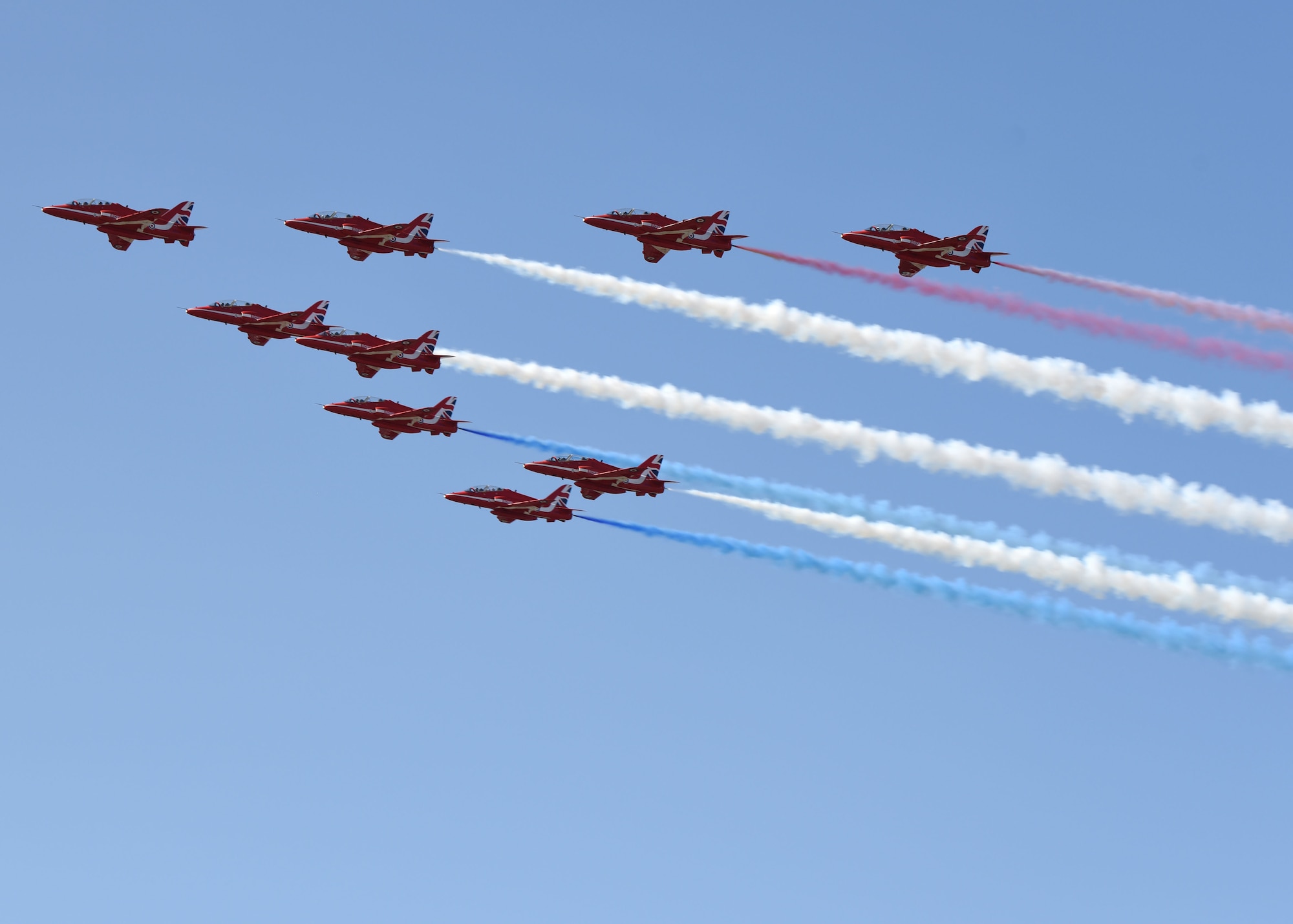 The Royal Air Force Aerobatic Team, known as the Red Arrows, performs a flyover as part of the U.S. Air Force's 73rd birthday and 80th anniversary of the Battle of Britain at RAF Mildenhall, England, Sept. 18, 2020. Team Mildenhall hosted a food truck rally and piano burn to honor these anniversaries. (U.S. Air Force photo by Karen Abeyasekere)