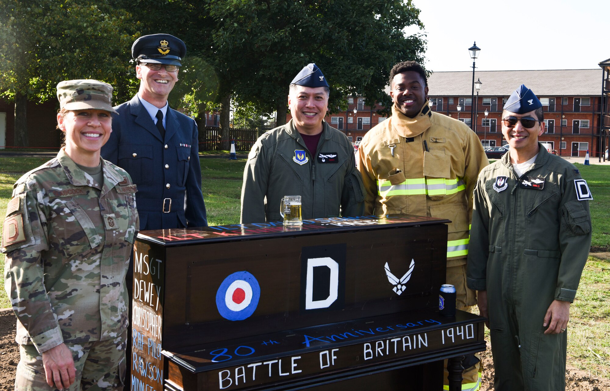 From left to right, U.S. Air Force Chief Master Sgt. Kathi Glascock, 100th Air Refueling Wing command chief, Royal Air Force Squadron Leader Paul Graham, RAF Mildenhall commander, Col. Van Thai, 100th Operations Group commander, Staff Sgt. Dajuantaye Brown, 100th Civil Engineer Squadron lead firefighter, and Col. Troy Pananon, 100th ARW commander, gather for a piano burn at RAF Mildenhall, England, Sept. 18, 2020. The piano burn is a RAF tradition and this year’s commemorated the 80th anniversary of the Battle of Britain.  (U.S. Air Force photo by Airman 1st Class David Busby)