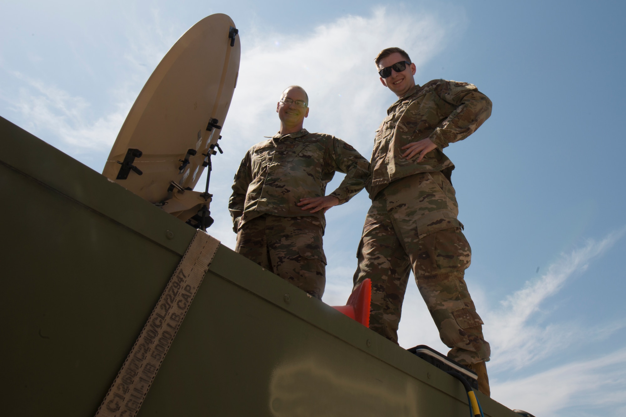 Two Airman pose for a photo.