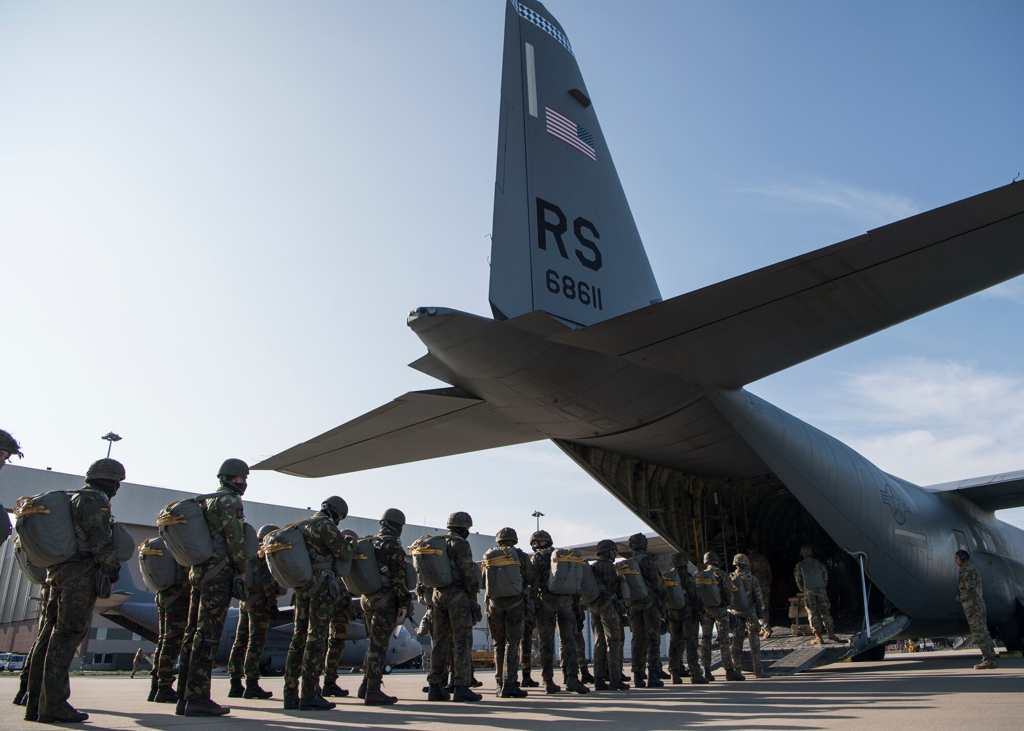 Belgian, Dutch and German airborne military members board a C-130J Super Hercules aircraft, assigned to the 37th Airlift Squadron, at Eindhoven Air Base, Netherlands, Sept. 18, 2020.