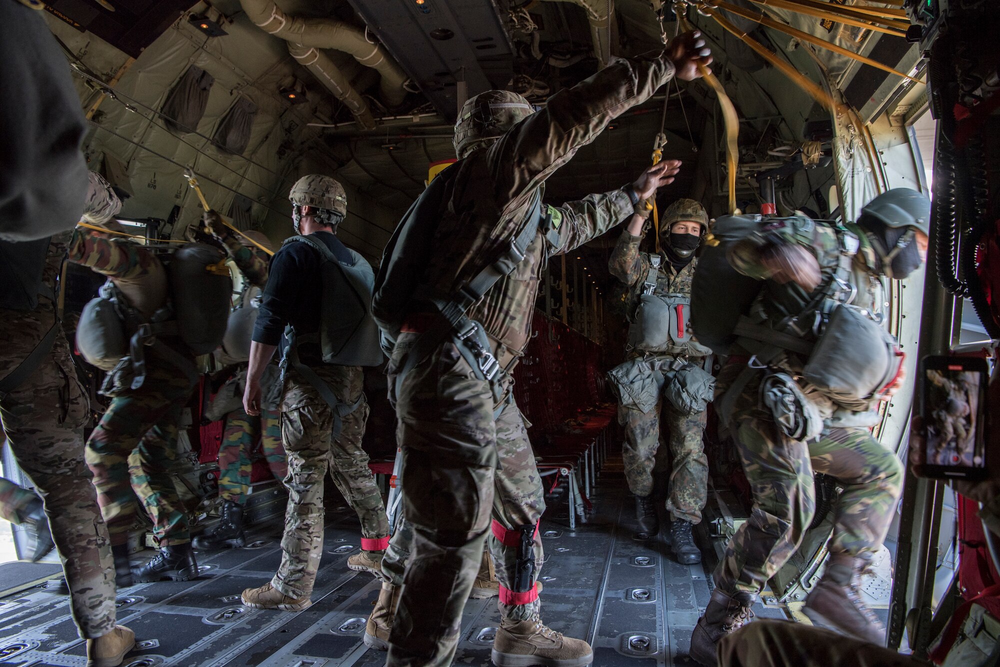 U.S. Army jumpmasters support Belgian, Dutch and German airborne military members while they perform a static line airdrop over the Netherlands, Sept. 18, 2020.