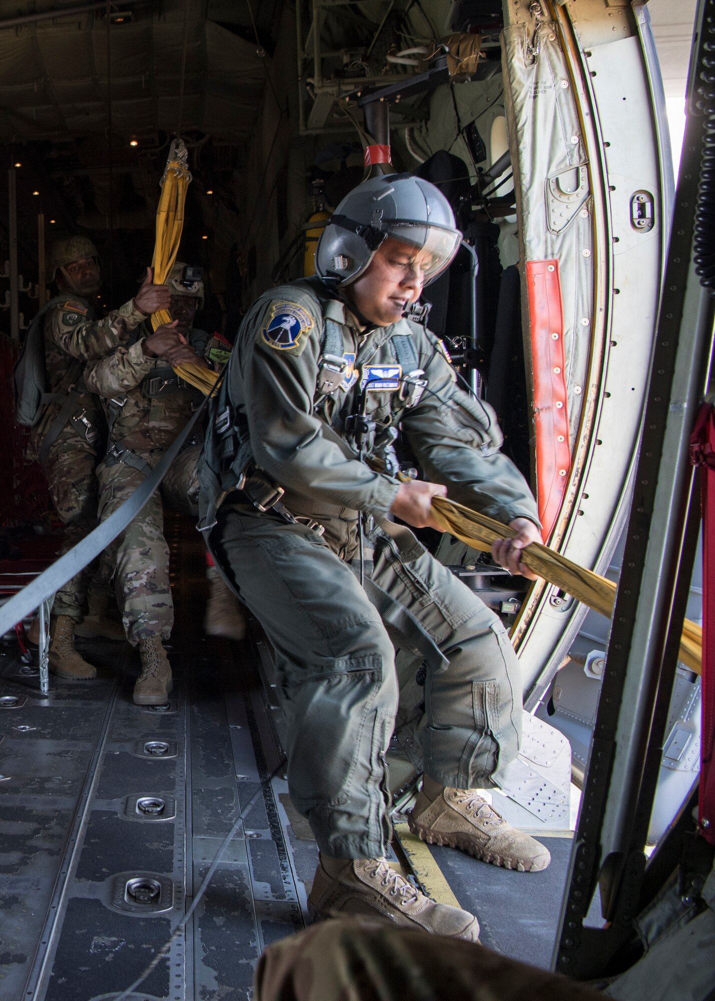 U.S. Air Force Staff Sgt. Bruno Ruiz Camacho, 37th Airlift Squadron loadmaster, pulls static lines after a personnel drop over the Netherlands, Sept. 18, 2020.