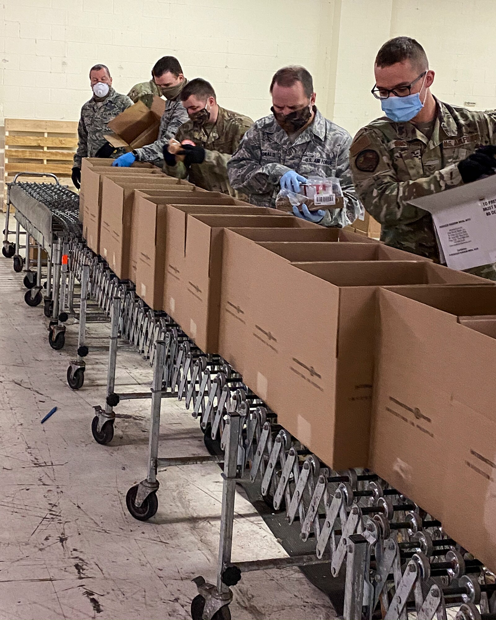 Airmen from the 127th Wing at Selfridge Air National Guard Base, Mich., pack food boxes at Forgotten Harvest Food Pantry in Royal Oak, Michigan on April 22, 2020.  On an average day the Airmen are able to prepare and pack more than 3,500 boxes of food.  The food pantry delivers more than 138,000 pounds of food per day to Michiganders throughout the Metro Detroit area.  Since March 30, Michigan National Guard members have also been supporting local communities at food banks in Comstock Park, Ann Arbor, Pontiac, and Flint. (U.S. Air National Guard photo by Phillip Ulmer)