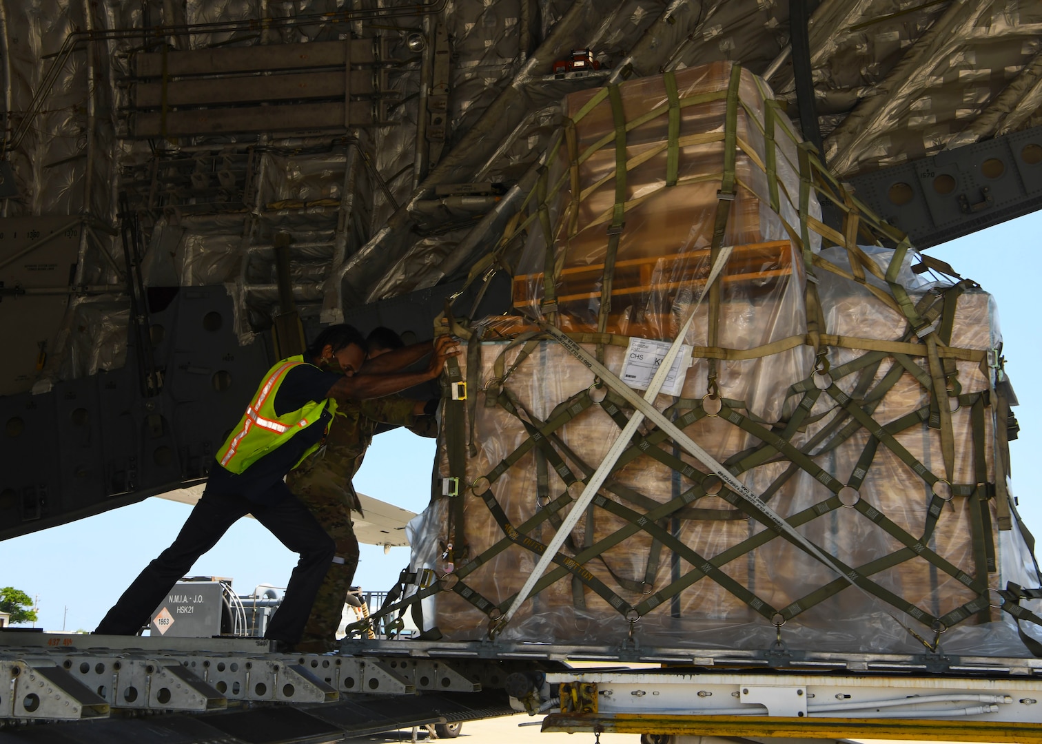 Military personnel offload a mobile field hospital from a C-17 Globemaster III at Norman Manley International Airport in Kingston, Jamaica, Sept. 19, 2020.