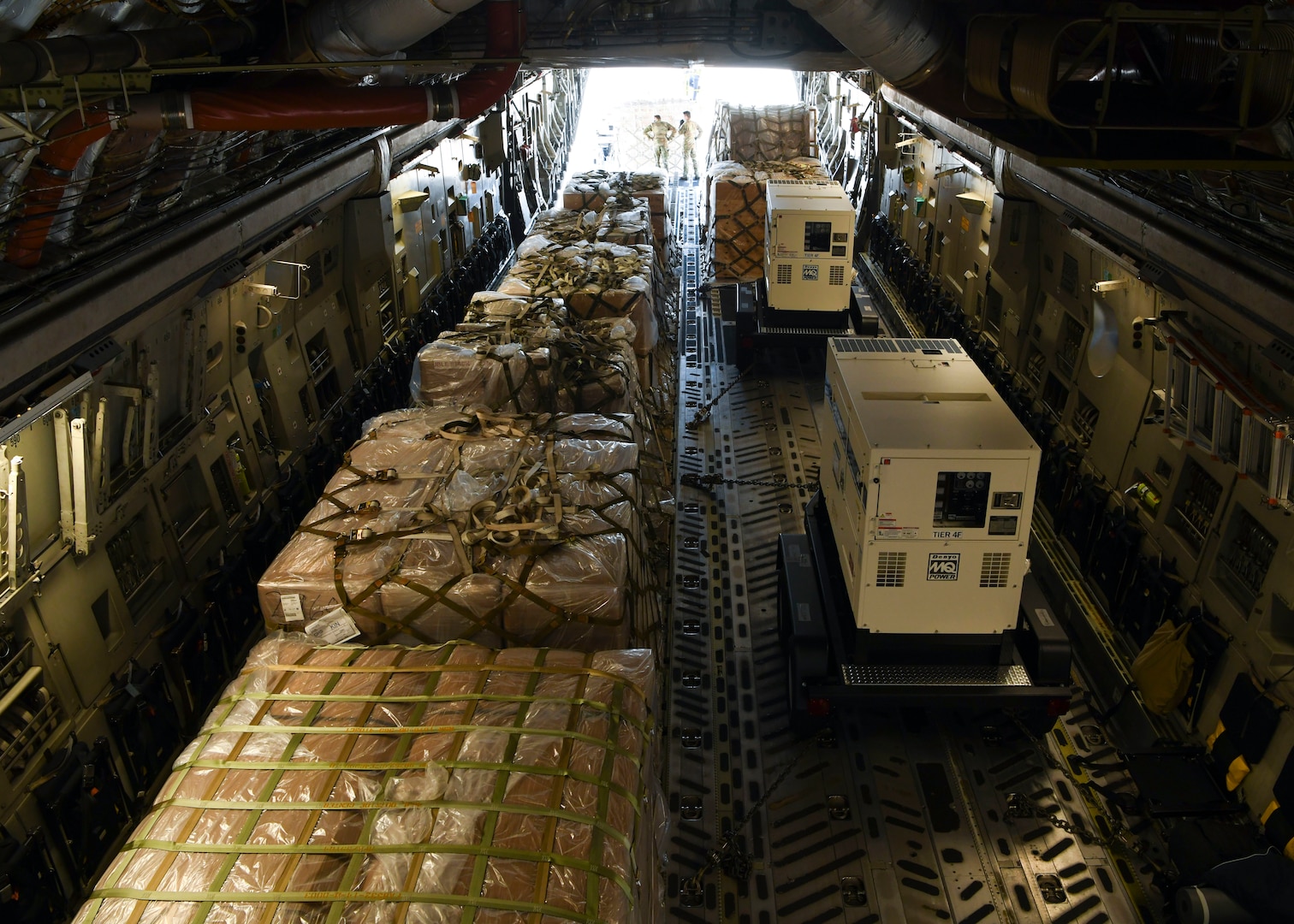 Military personnel offload a mobile field hospital from a C-17 Globemaster III at Norman Manley International Airport in Kingston, Jamaica, Sept. 19, 2020.