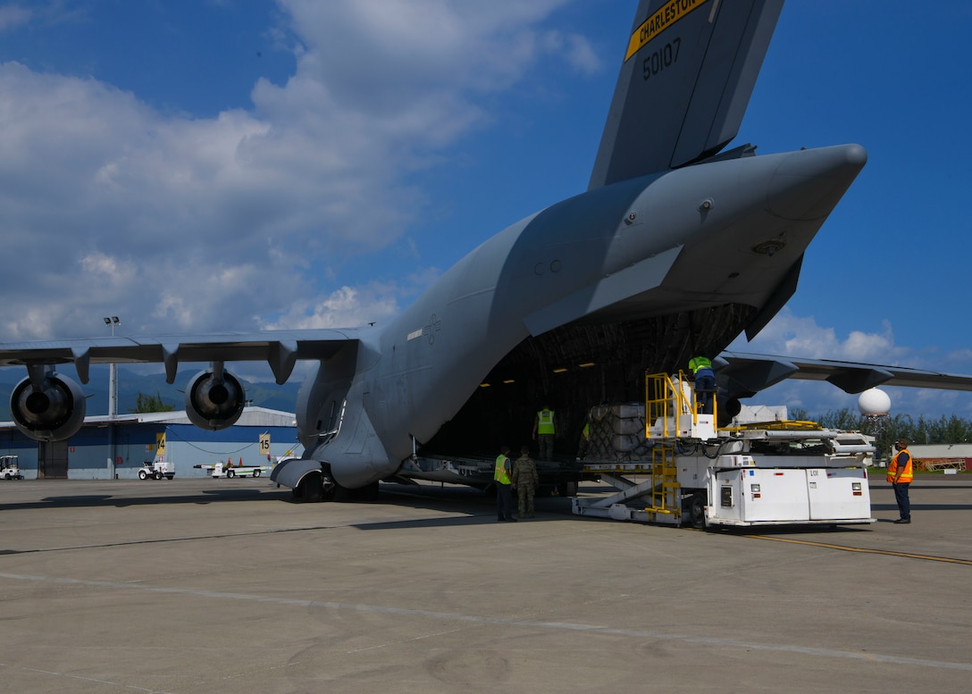 Military personnel offload a mobile field hospital from a C-17 Globemaster III at Norman Manley International Airport in Kingston, Jamaica, Sept. 19, 2020.