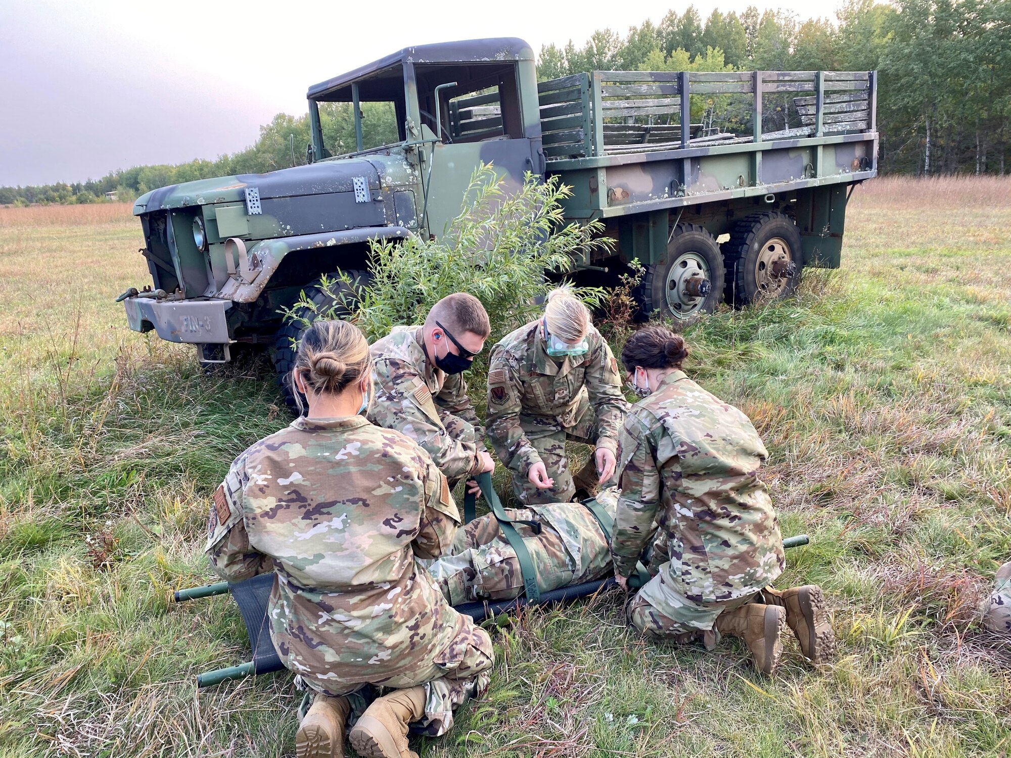 Aerospace Medical Technicians with the 148th Fighter Wing, Minnesota Air National Guard provide response to a patient during medical evacuation training with the 2-211 General Aviation Support Battalion, Minnesota Army National Guard, at Camp Ripley Training Center, Minnesota on Saturday, September 20, 2020.