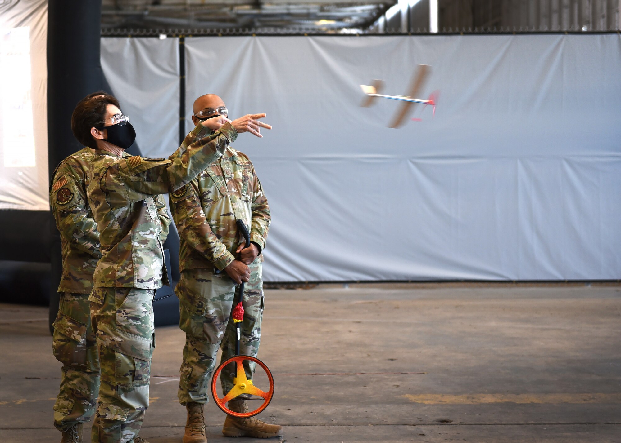 Photo of an individual throwing a test flight airplane.