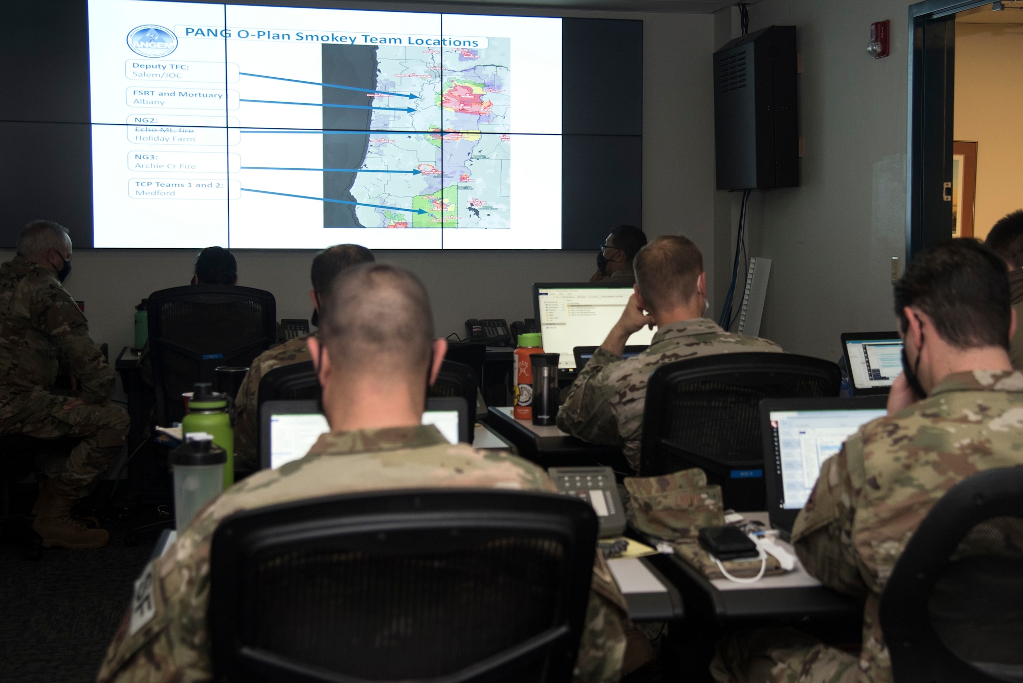 Guardsmen from the 142nd Wing work in the Emergency Operation Center in support of Operation Plan Smokey at the Portland Air National Guard Base, Ore.,  Sept. 18, 2020. The EOC team communicates with the Oregon Joint Operation Center to provide emergency management for scenarios such as the state's recent wildfires. (U.S. Air National Guard photo by Senior Airman Valerie R. Seelye)