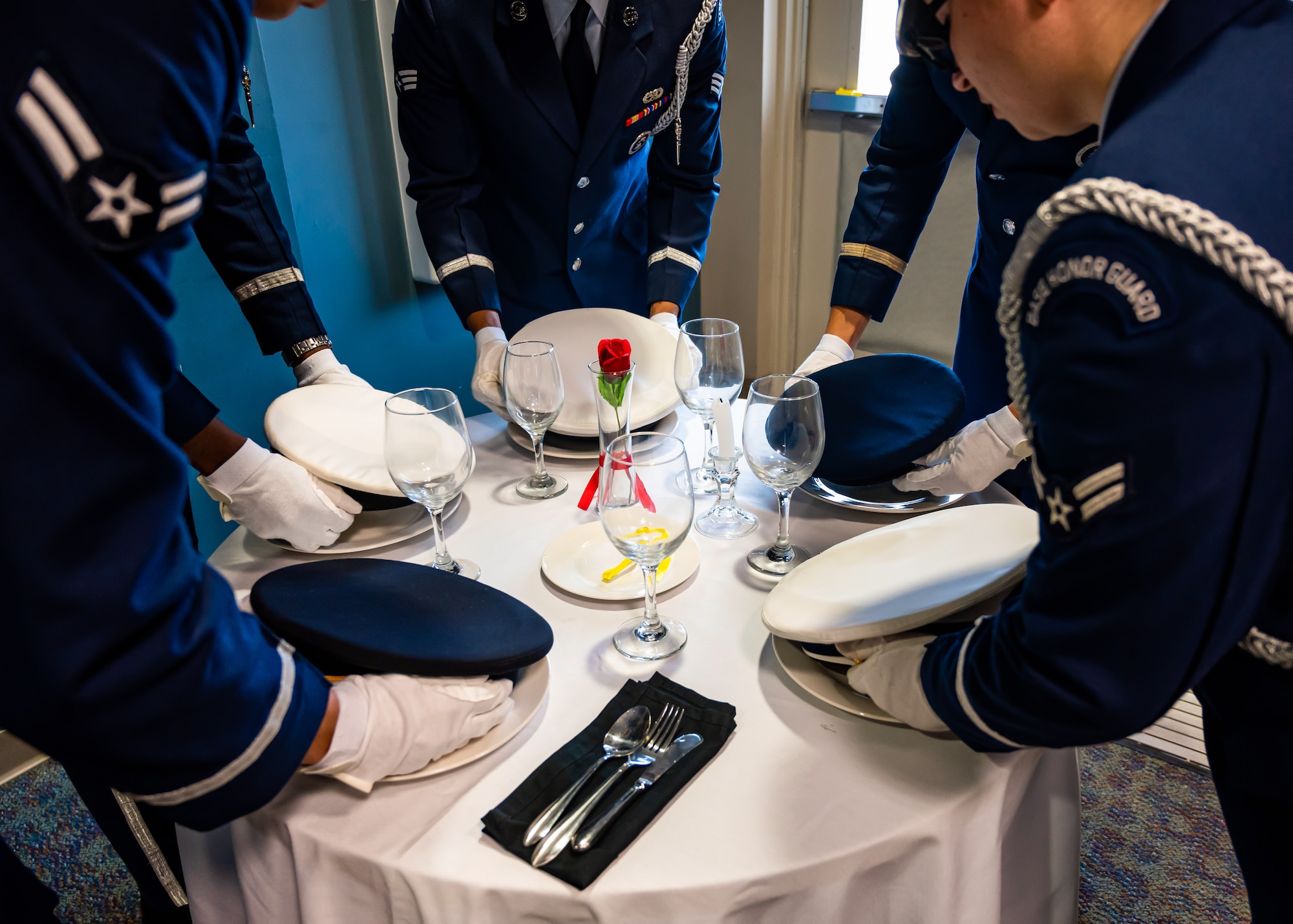 Airmen set a powmia table.