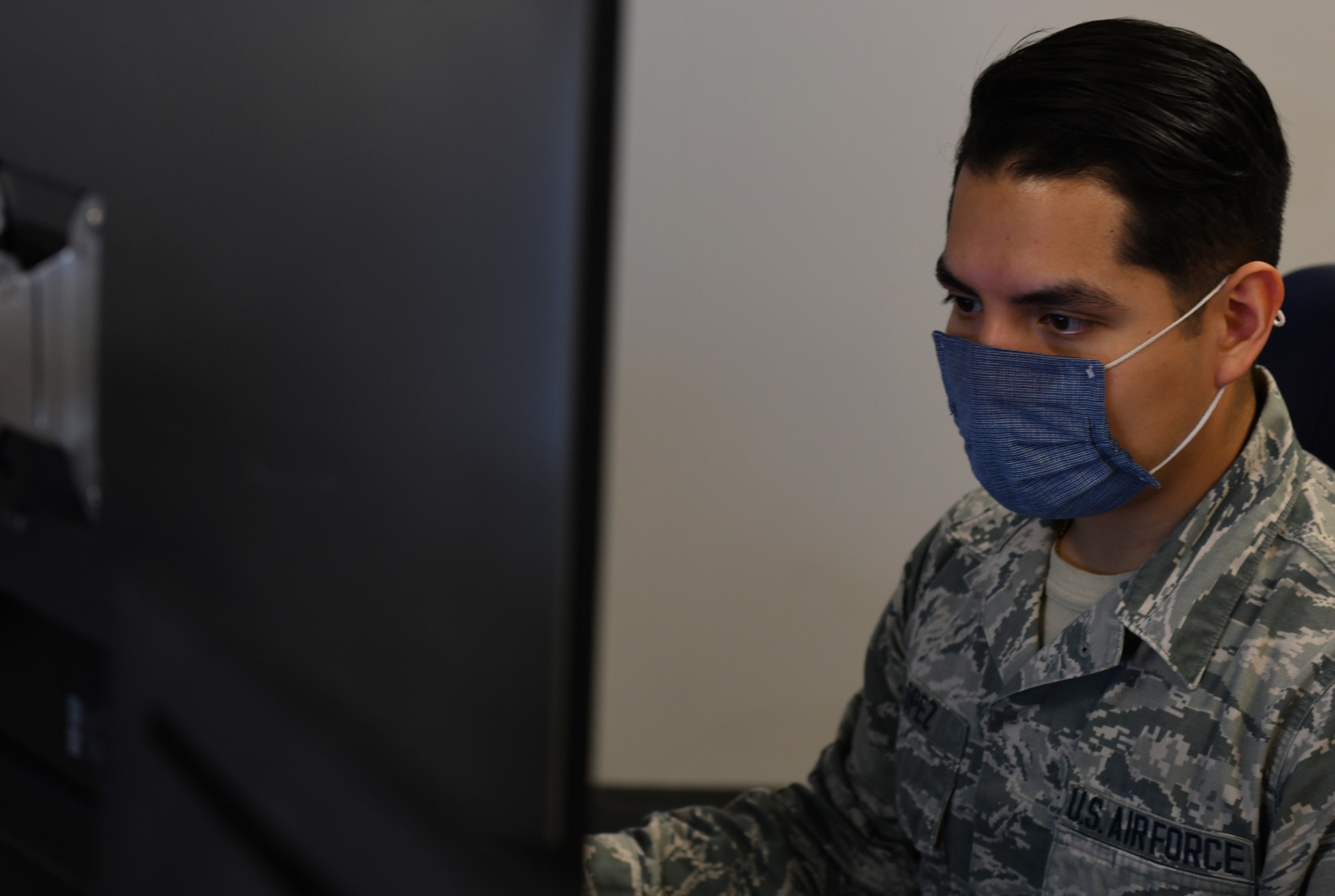 A 62d Cyberspace Squadron Airman monitors his workstation for activity at Buckley Air Force Base, Colo. (U.S. Space Force photo by Staff Sgt. Timothy R. Kirchner)