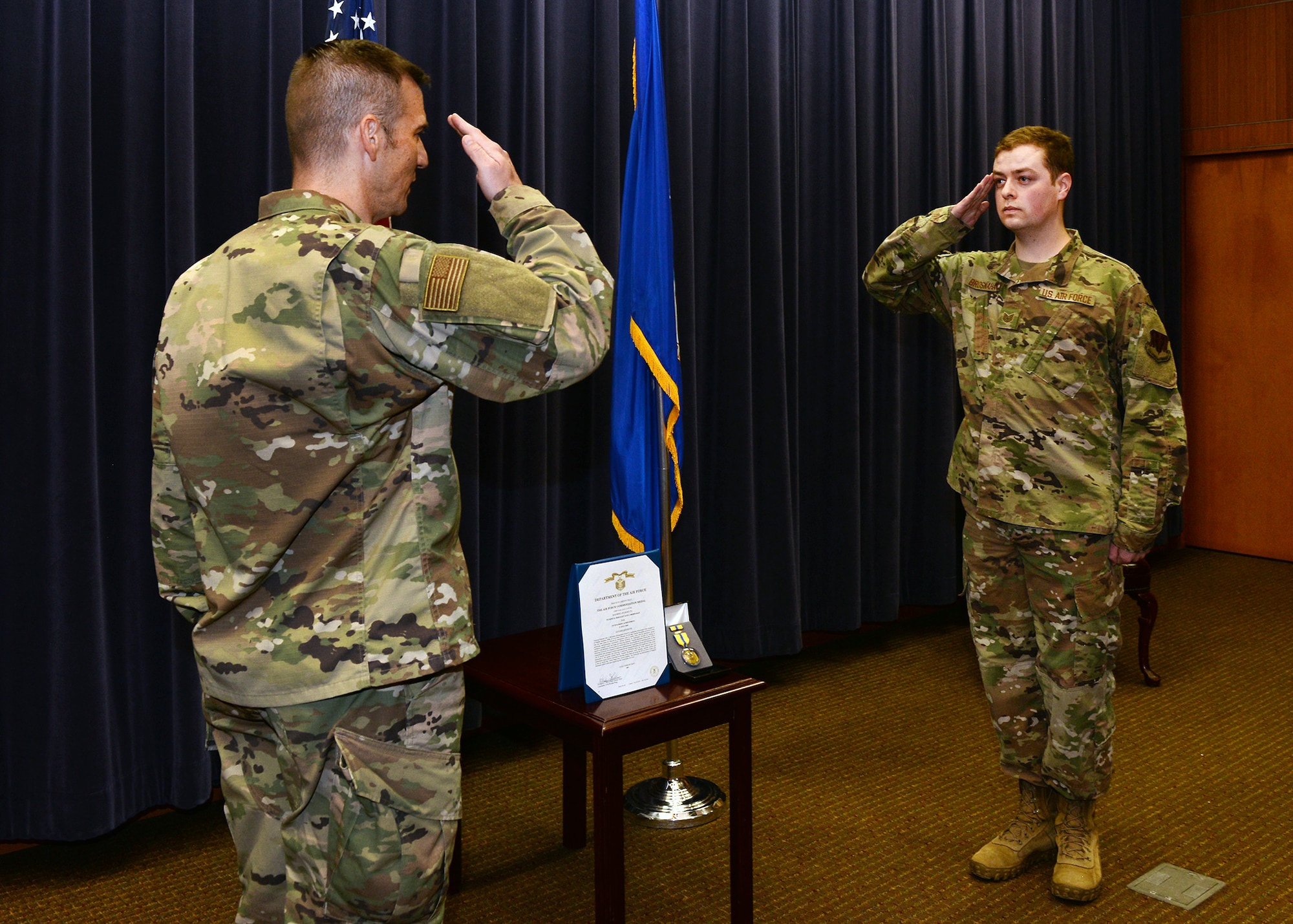 Col. Patrick Williams, 557th Weather Wing commander, presents the Air Force Commendation Medal to Tech. Sgt. Alex Brosnahan, 2d Weather Squadron, for saving another service member's life on Aug. 4, 2020 at Offutt Air Force Base, Nebraska.