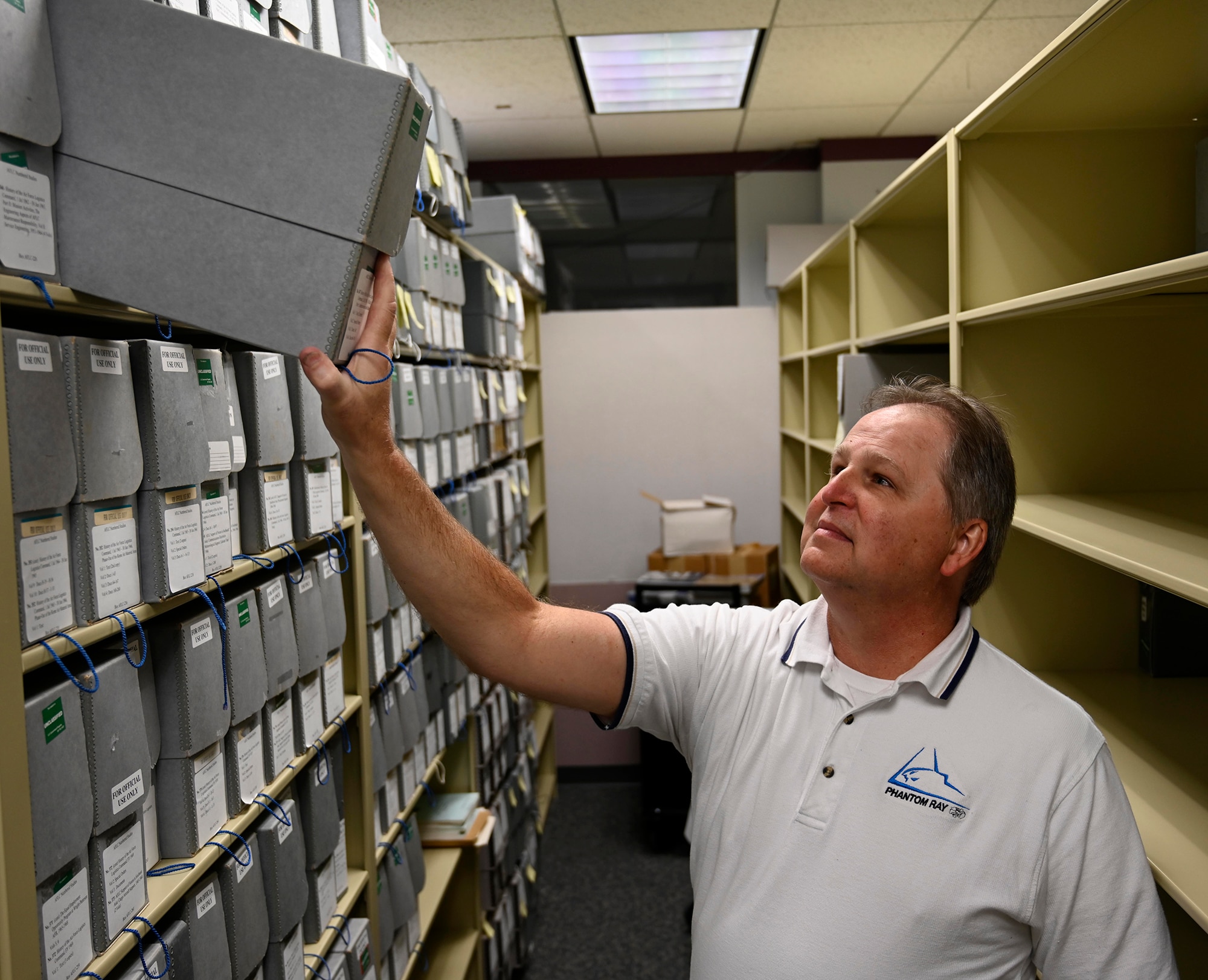 Tony Landis, Air Force Materiel Command Historian, checks for an archive within the History and Heritage Program office at the AFMC Headquarters, Wright-Patterson Air Force Base, Ohio. (Air Force photo by Darrius Parker)