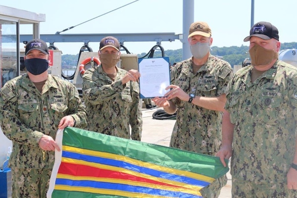 Capt. Andrew Miller, Submarine Squadron 4 commodore, second from right, presents the Meritorious Unit Commendation (MUC) to the crew of the Virginia-class fast-attack submarine USS Minnesota (SSN 783), July 9, 2020.