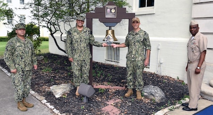 Cmdr. Nicholas Gamiz (right center), Navy Recruiting District San Antonio commanding officer, is joined by (from left) Command Master Chief Francisco Valdovinos, Cmdr. Michael Files, and Master Chief Matthew Maduemesi, along with the 2004 Navy Recruiting Command’s Bronze “R” Award at NRD-SA headquarters at Joint Base San Antonio-Fort Sam Houston.  The NRD was awarded the Bronze “R” by the Navy Recruiting Command for its performance during the first half of fiscal year 2020.