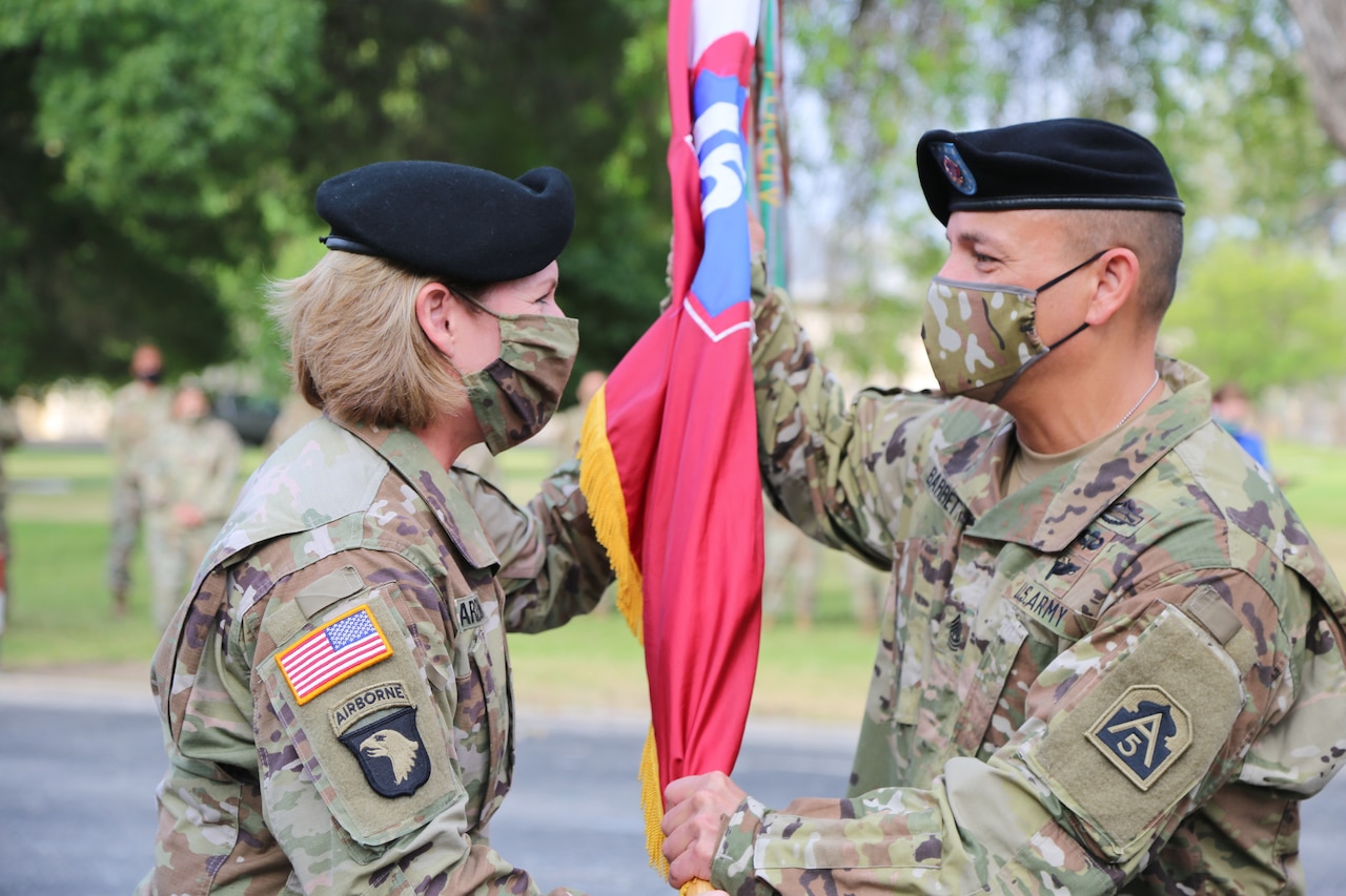 Army Lt. Gen Laura J. Richardson gives Army Command Sgt. Maj. Phil K. Barretto a command flag.