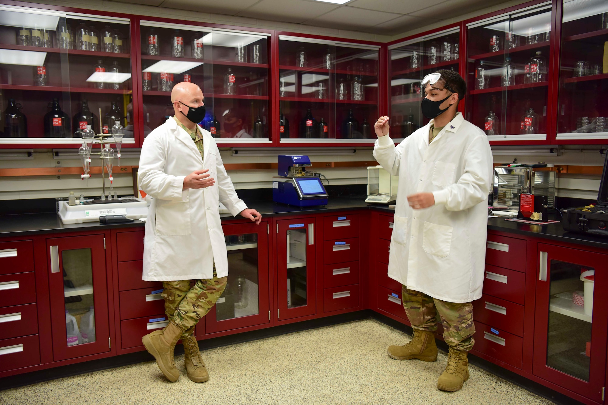 U.S. Air Force Col. David Berkland, the 354th Fighter Wing commander, talks to Senior Airman Michael Moore, a 354th Logistics Readiness Squadron fuels laboratory technician, during a wing leadership immersion at Eielson Air Force Base, Alaska, Sept. 22, 2020.