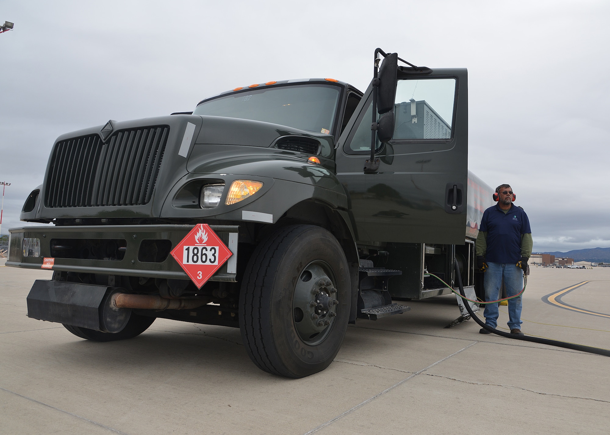 Man stands by fuel truck
