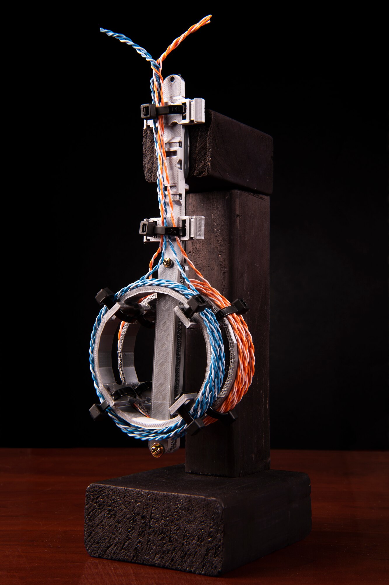 A 3D printed model of a cable management device invented by Senior Airman Hartman, 726th Air Command Squadron cyber transport technician, sits on display, Sept. 16, 2020, at Mountain Home Air Force Base, Idaho. The device helps gather loose cable and organize it to make for a more efficient and safe work environment. (U.S. Air Force photo by Senior Airman Andrew Kobialka)