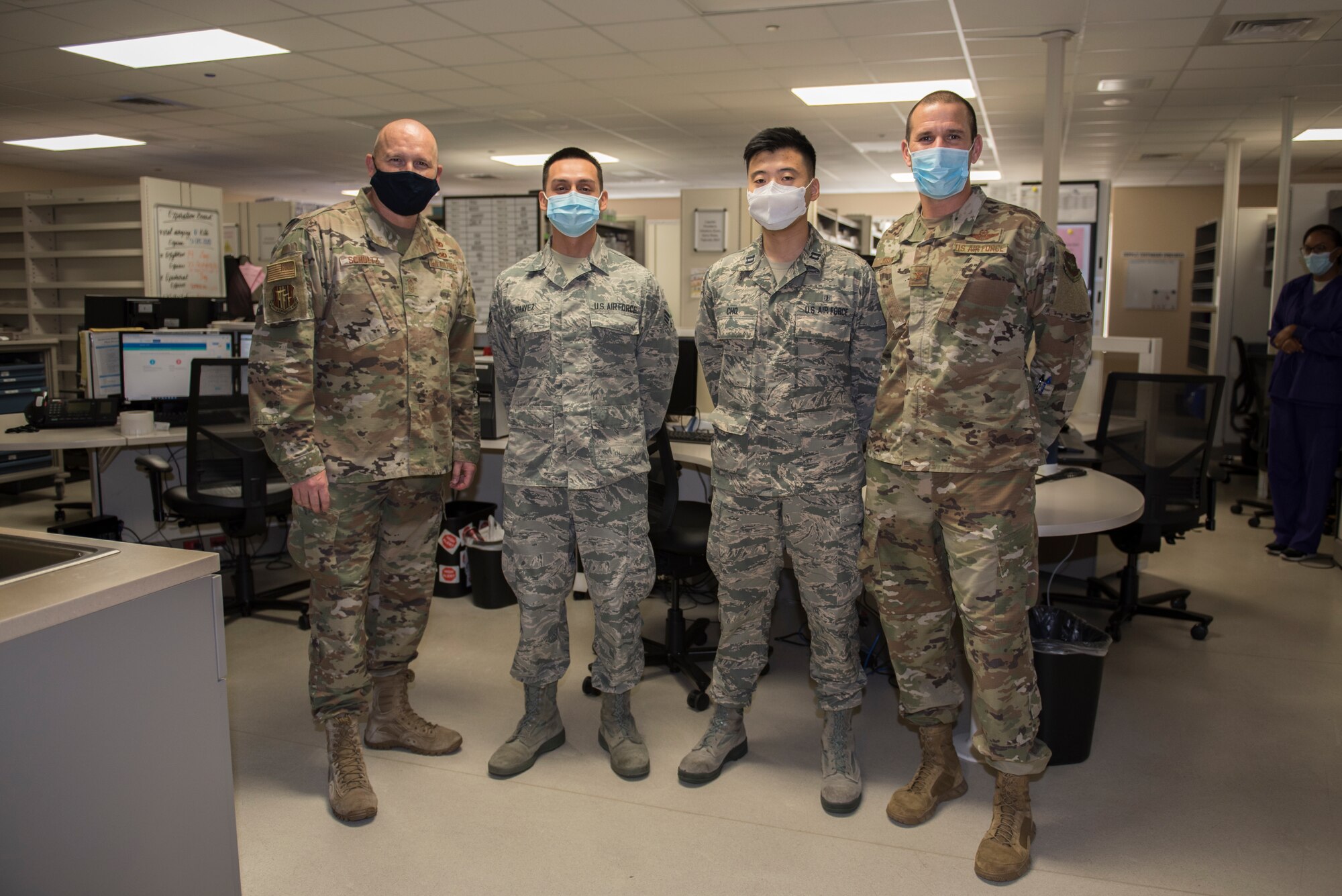 U.S. Air Force Col. Zachery Jiron, 60th Air Mobility Wing vice commander, right, and Chief Master Sgt. Robert Schultz, 60th AMW command chief, left, recognize Senior Airman Marcello Chavez, 60th Medical Diagnostics and Therapeutic Squadron inpatient pharmacy technician, second from left, and Capt. Andrew Cho, 60th MDTS inpatient staff pharmacist, as star performers Sept. 18, 2020, at Travis Air Force Base, California. The Leadership Rounds program provides 60th AMW leadership an opportunity to interact with Airmen and get a detailed view of each mission performed at Travis AFB. (U.S. Air Force photo by Senior Airman Cameron Otte)