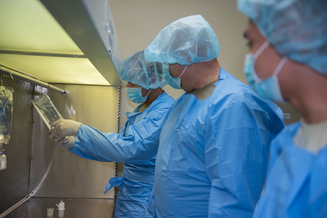 U.S. Air Force Senior Airman Marcello Chavez, right, 60th Medical Diagnostics and Therapeutic Squadron inpatient pharmacy technician, demonstrates production of an antibiotic to Col. Zachery Jiron, 60th Air Mobility Wing vice commander, left, and Chief Master Sgt. Robert Schultz, 60th AMW command chief, Sept. 18, 2020, at Travis Air Force Base, California. The Leadership Rounds program provides 60th AMW leadership an opportunity to interact with Airmen and get a detailed view of each mission performed at Travis AFB. (U.S. Air Force photo by Senior Airman Cameron Otte)