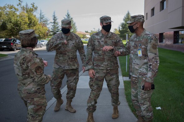 U.S. Air Force Col. Bernard Vanpelt, right, 60th Medical Diagnostics and Therapeutic Squadron deputy commander, and Chief Master Sgt. Nicole Sanders, left, 60th MDTS superintendent, greets Col. Zachary Jiron, second from right, 60th Air Mobility Wing vice commander, and Chief Master Sgt. Robert Schultz 60 th AMW command chief, Sept. 18, 2020, at Travis Air Force Base, California. The Leadership Rounds program provides 60th AMW leadership an opportunity to interact with Airmen and get a detailed view of each mission performed at Travis AFB. (U.S. Air Force photo by Senior Airman Cameron Otte)