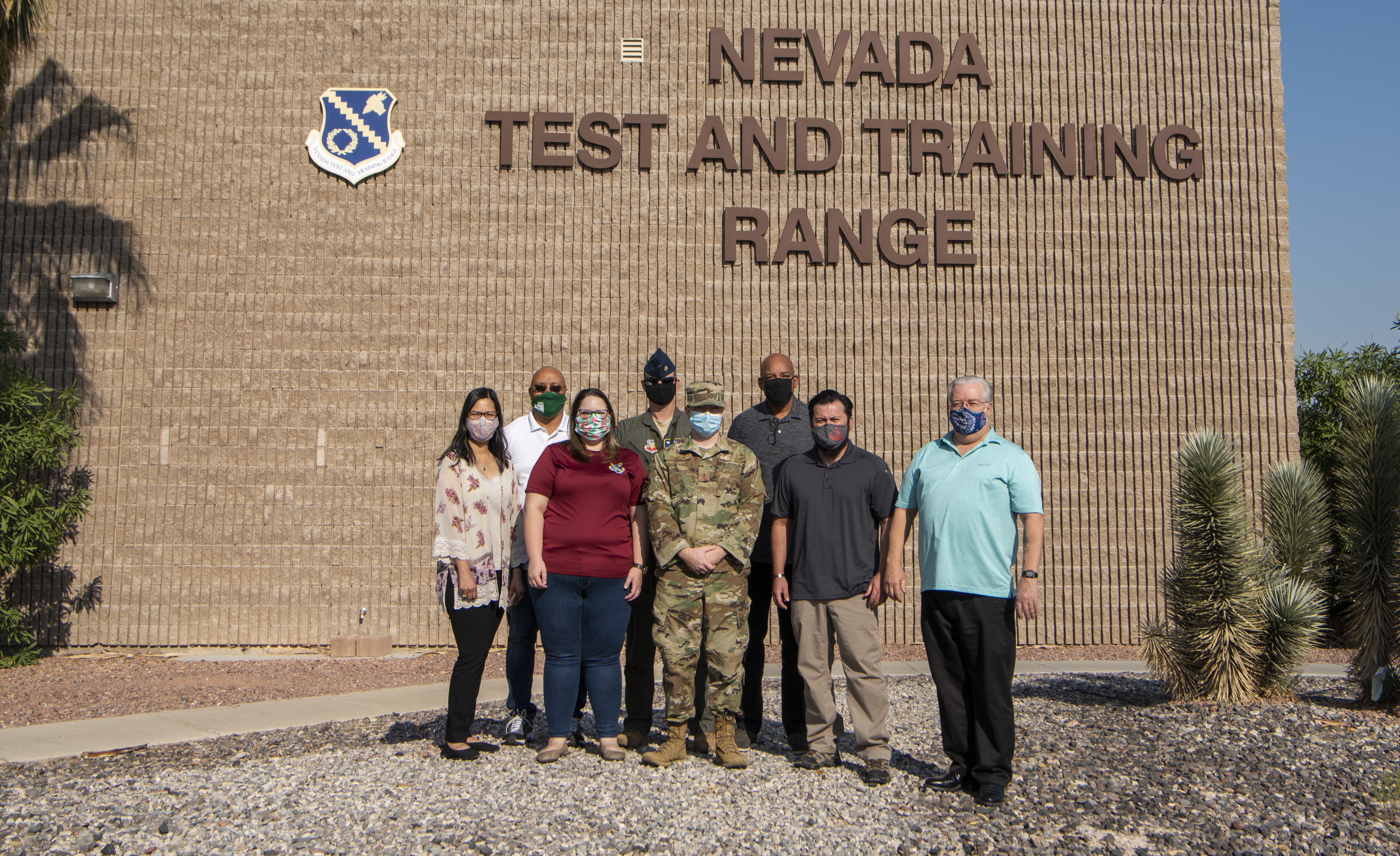 Nevada Test and Training Range (NTTR) project managers pose for a photo outside of the NTTR headquarters building at Nellis Air Force Base, Nevada, Sept. 22, 2020. Project Managers are responsible for execution oversight of exercises supported by the NTTR. They oversee exercise support and airspace scheduling for real-time operations of the range monitoring facility. (U.S. Air Force photo by Airman 1st Class Dwane R. Young)