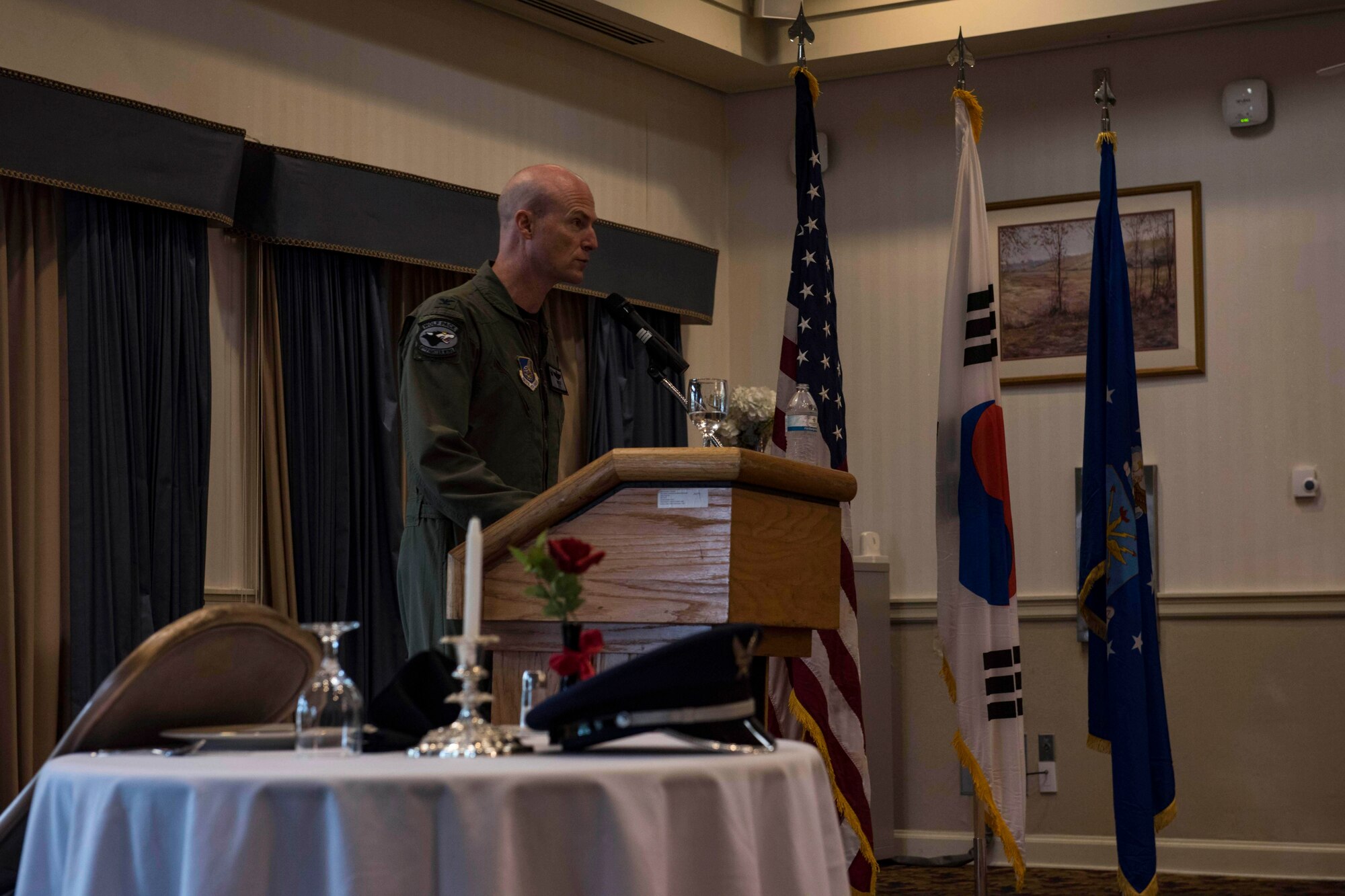 A photo of a base commander giving a speech during a ceremony.
