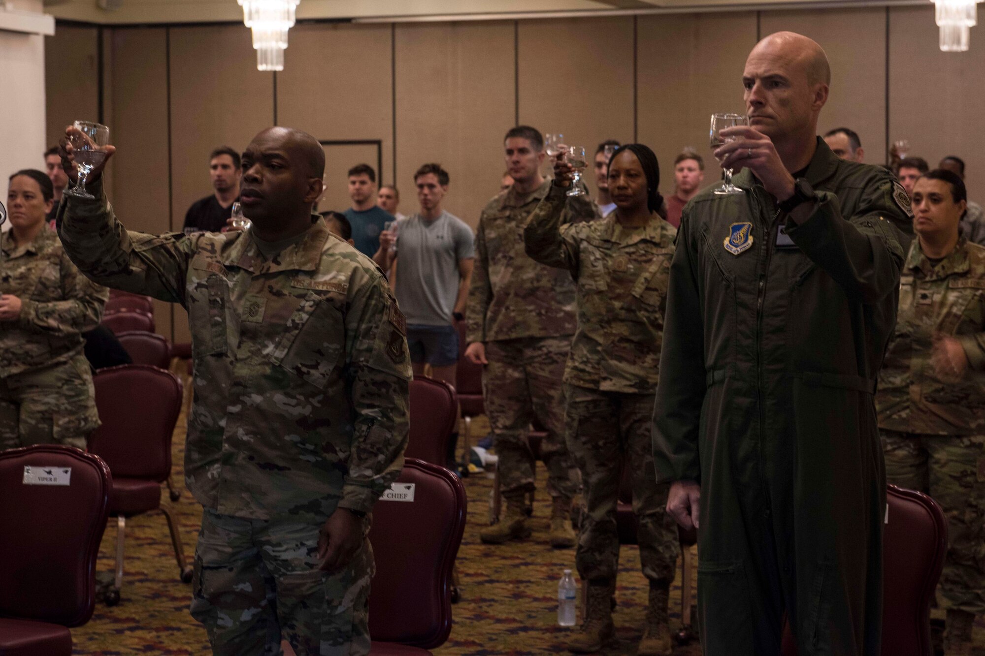 A photo of Airmen making a toast during a ceremony.
