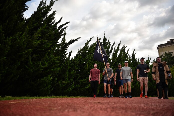 A photo of Airmen walking a lap in honor of POW/MIA week.