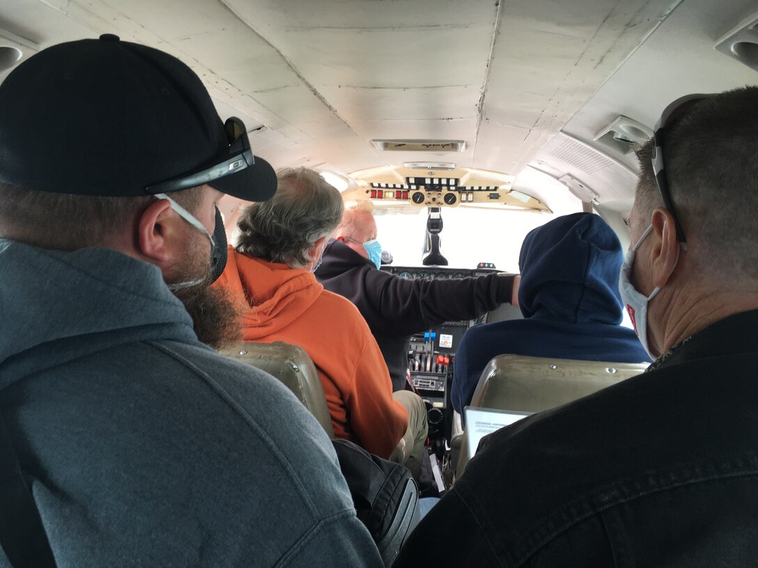 U.S. Army Reserve Lt. Col. Hugh Douglas (Right Rear), governance and participation section chief for the 351st Civil Affairs Command, Functional Specialty Team (FxSP) flies on board a Piper Navajo (PA-31) aircraft, traveling from Cold Bay to Dutch Harbor (Unalaska), Alaska during the Innovative Readiness Training (IRT) Civil-Military Partnership, Leaders’ Reconnaissance, July 22, 2020. IRT is a joint training concept that the Department of Defense (DOD) implemented to increase unit deployment readiness, leveraging the military contributions of U.S. Armed Forces capabilities, combined with local resources to build strong civil-military partnerships for communities in the contiguous United States and its territories.