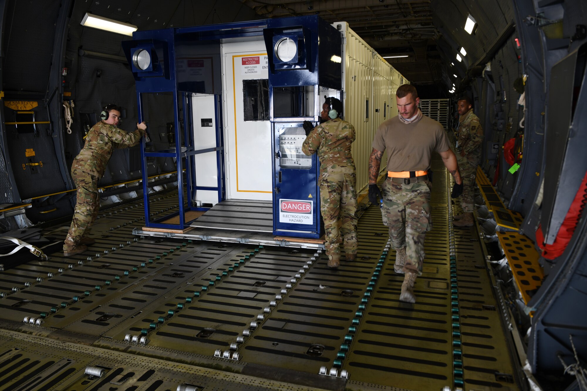 Airmen prepare to off load a specialized medical container designed to transport individuals with infectious diseases at Al Udeid Air Base, Qatar, Sept. 18, 2020. The Negatively Pressurized Conex, or NPC, is configured for the C-17 Globemaster III and C-5 Super Galaxy aircraft to safely transport up to 28 passengers or 23 patients, including ambulatory and litter, around the globe. (U.S. Air Force photo by Staff Sgt. Kayla White)