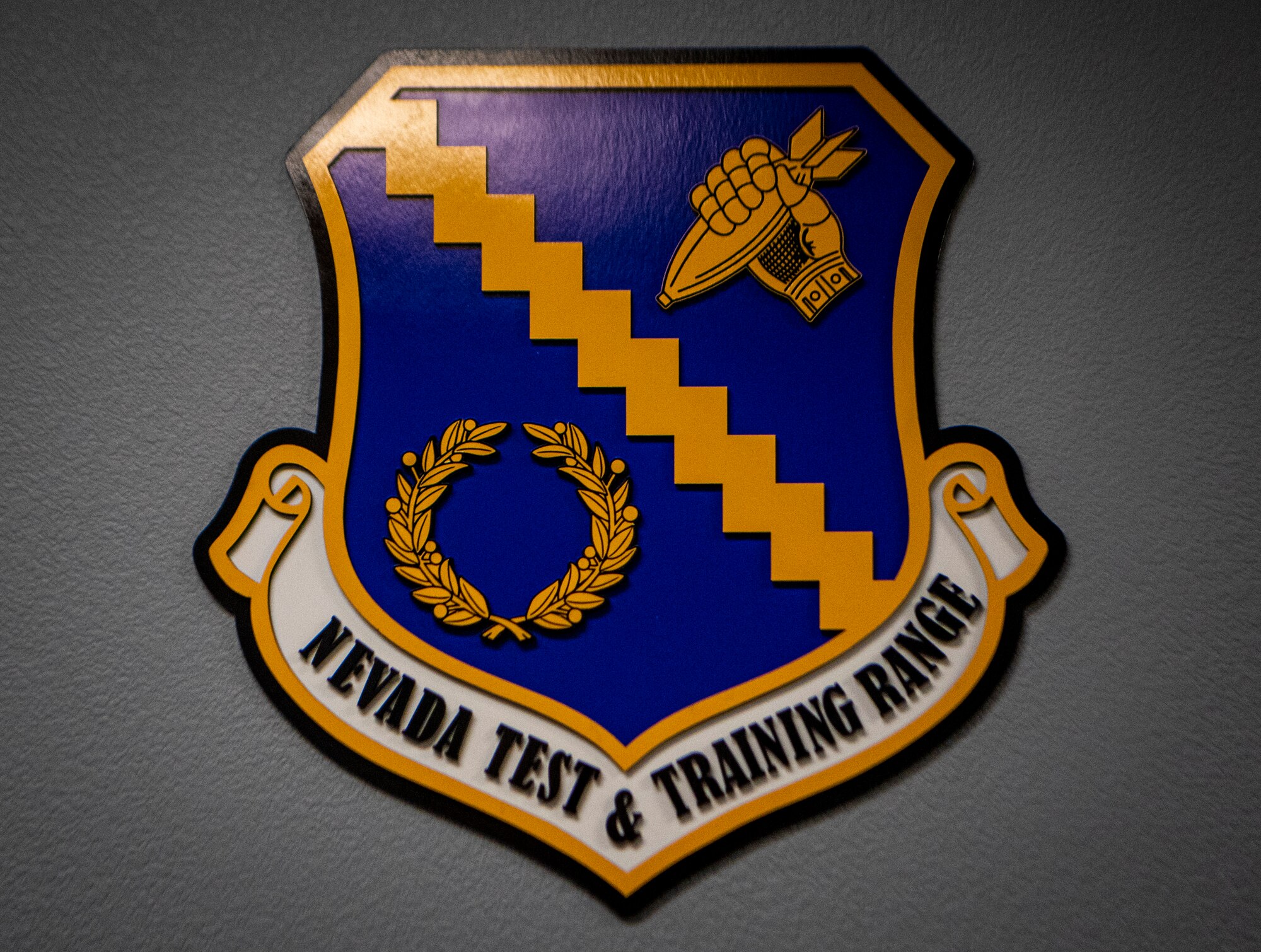 Nevada Test and Training Range crest on a wall.