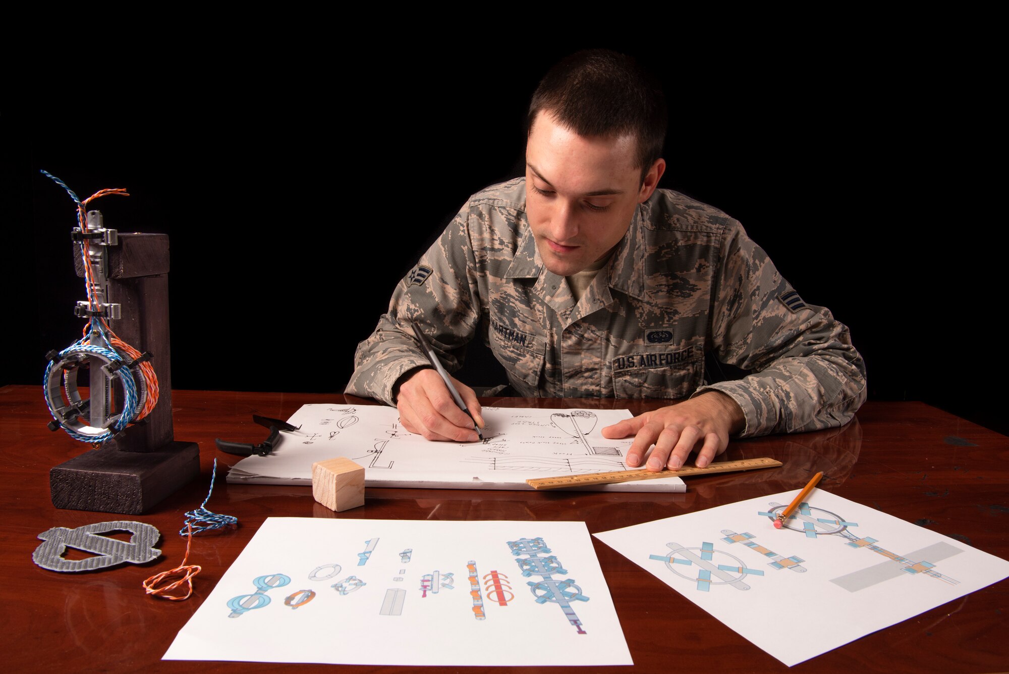 Senior Airman Hartman, 726th Air Command Squadron cyber transport technician, sketches an idea for his invention of a cable management system, Sept. 16, 2020, at Mountain Home Air Force Base, Idaho. Hartman was selected to compete at the Air Combat Command level through the Spark Tank Challenge, which creates an avenue for Airmen to present their ideas to senior leadership. (U.S. Air Force photo by Senior Airman Andrew Kobialka)
