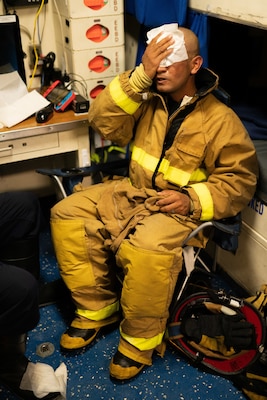 Seaman Dominique Diego on board Coast Guard Cutter Waesche wipes away sweat after returning from battling a fire onboard the cutter in the Western Pacific Ocean, September 19th 2020. The Waesche’s deployment to the region was in direct support of the U.S. Foreign Policy and National Security objectives in the region as outlined by the National Defense Strategy. (Coast Guard Photo by Petty Officer 3rd Class Aidan Cooney)