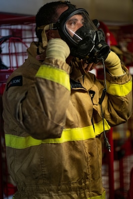 Petty Officer Third Class Bruce Duarte, a martime enforcement specialist onboard Coast Guard Cutter Waesche, tightens a self-contained breathing apparatus mask on his face before battling a fire on board the cutter in the Western Pacific Ocean, September 19th 2020. The Waesche’s deployment to the region was in direct support of the U.S. Foreign Policy and National Security objectives in the region as outlined by the National Defense Strategy. (Coast Guard Photo by Petty Officer 3rd Class Aidan Cooney)