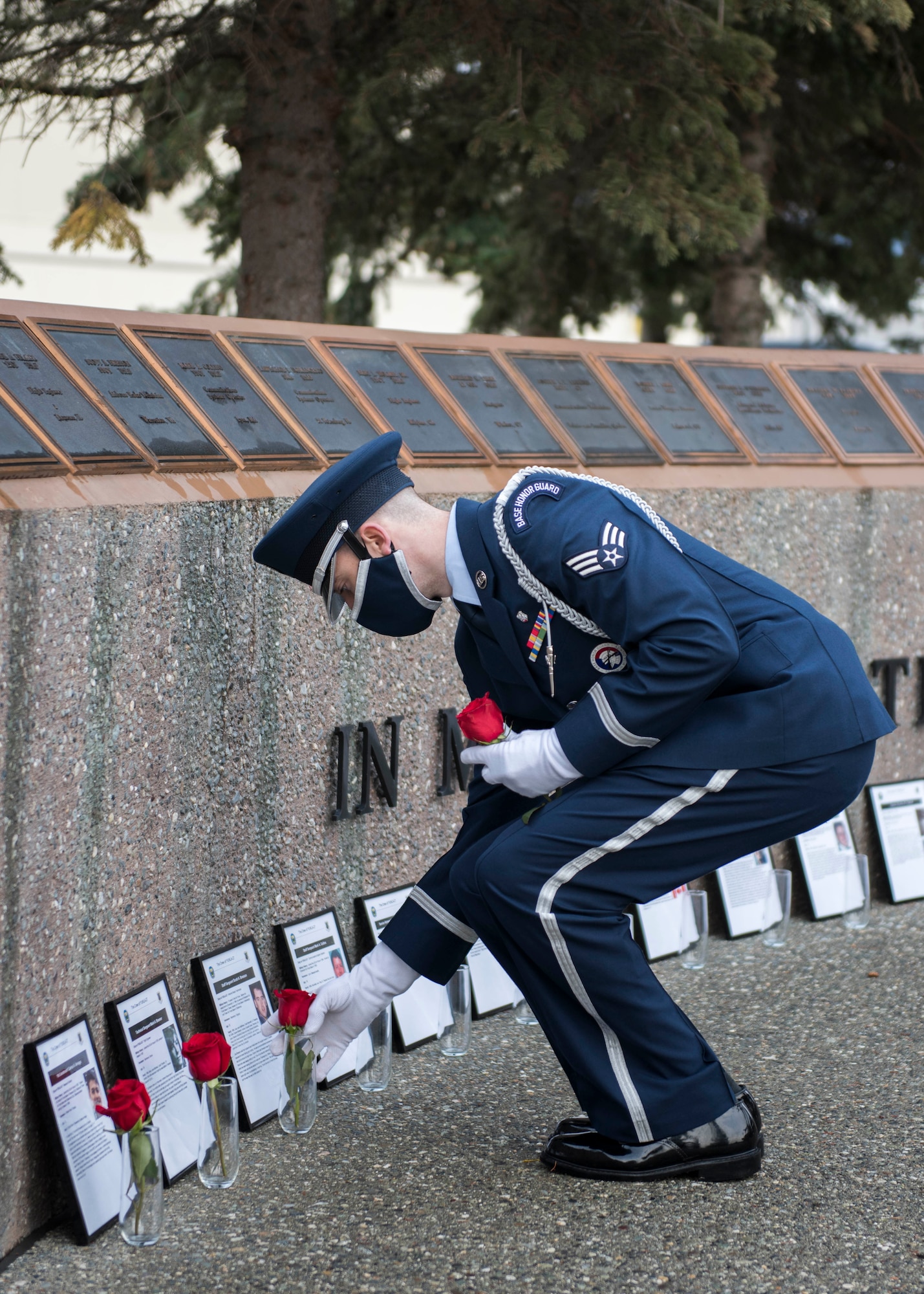 A U.S. Air Force Honor Guard member places a rose in front of a memorial for one of the lost crew members at the Yukla 27 25th anniversary memorial ceremony at Joint Base Elmendorf-Richardson, Alaska, Sept. 22, 2020. Yukla 27, a U.S. Air Force E-3 Sentry airborne warning and control system aircraft assigned to the 962nd AACS, encountered a flock of geese Sept. 22, 1995, and crashed shortly after takeoff on a routine surveillance training sortie, killing all 24 Canadian and U.S. Airmen aboard.