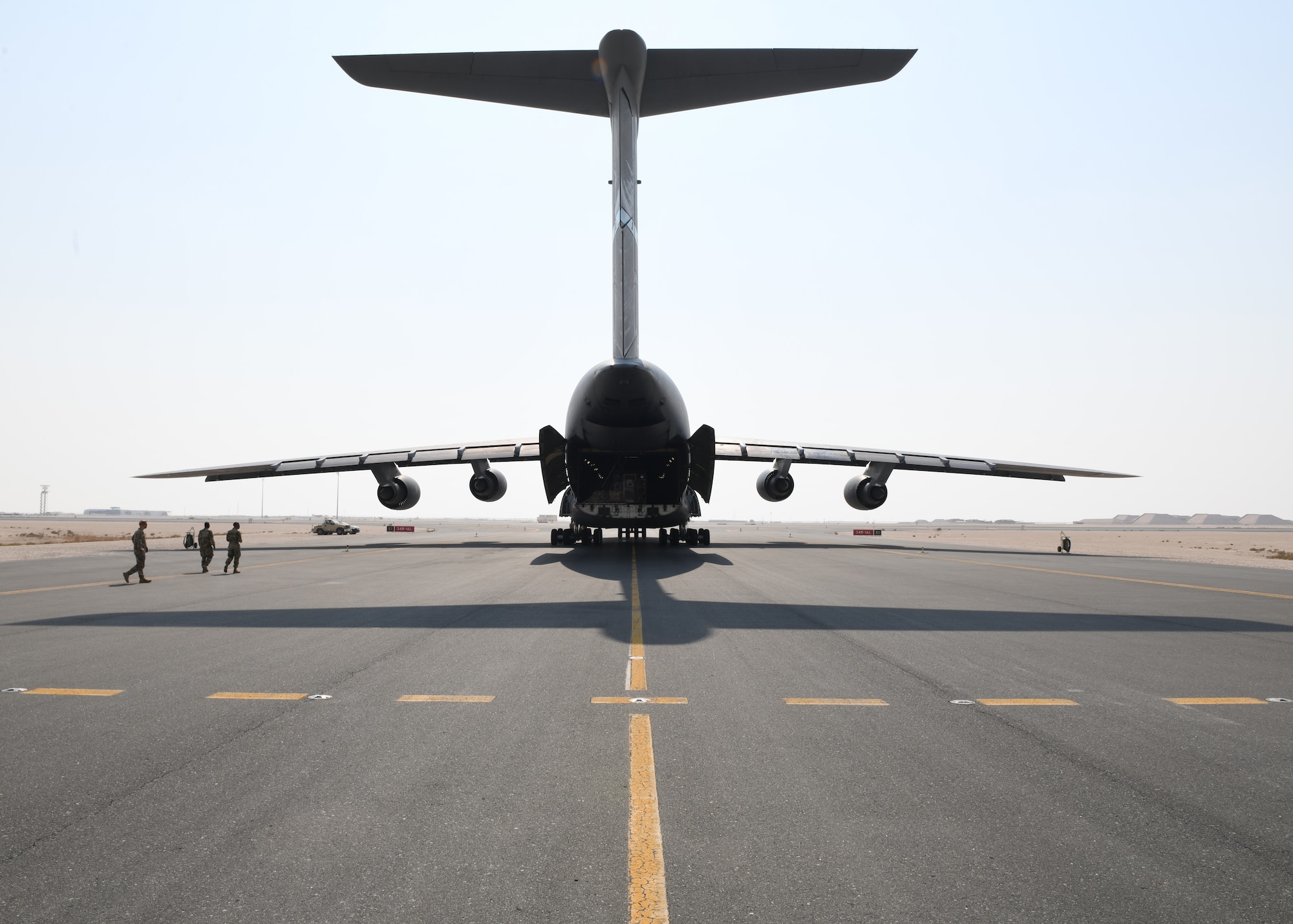 A C-5 Galaxy sits on the flight line of Al Udeid Air Base, Qatar, Sept. 18, 2020, to deliver a specialized medical container designed to transport individuals with infectious diseases. The Negatively Pressurized Conex, or NPC, is configured for the C-17 Globemaster III and C-5 Super Galaxy aircraft to safely transport up to 28 passengers or 23 patients, including ambulatory and litter, around the globe. (U.S. Air Force photo by Staff Sgt. Kayla White)