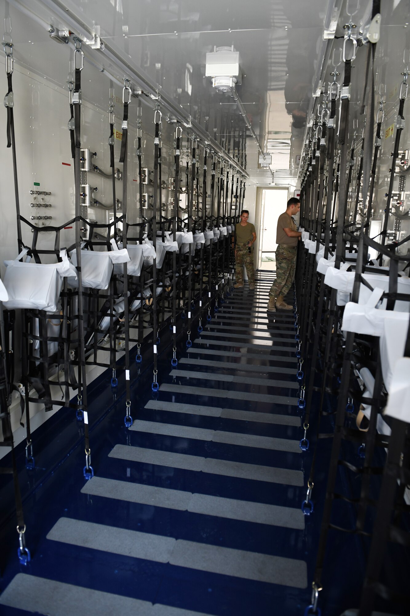 Airmen assigned to the 379th Expeditionary Aeromedical Evacuation Squadron deployed to Al Udeid Air Base, Qatar, inspect a specialized medical container designed to transport individuals with infectious diseases. The Negatively Pressurized Conex, or NPC, is configured for the C-17 Globemaster III and C-5 Super Galaxy aircraft to safely transport up to 28 passengers or 23 patients, including ambulatory and litter, around the globe. (U.S. Air Force photo by Staff Sgt. Kayla White)