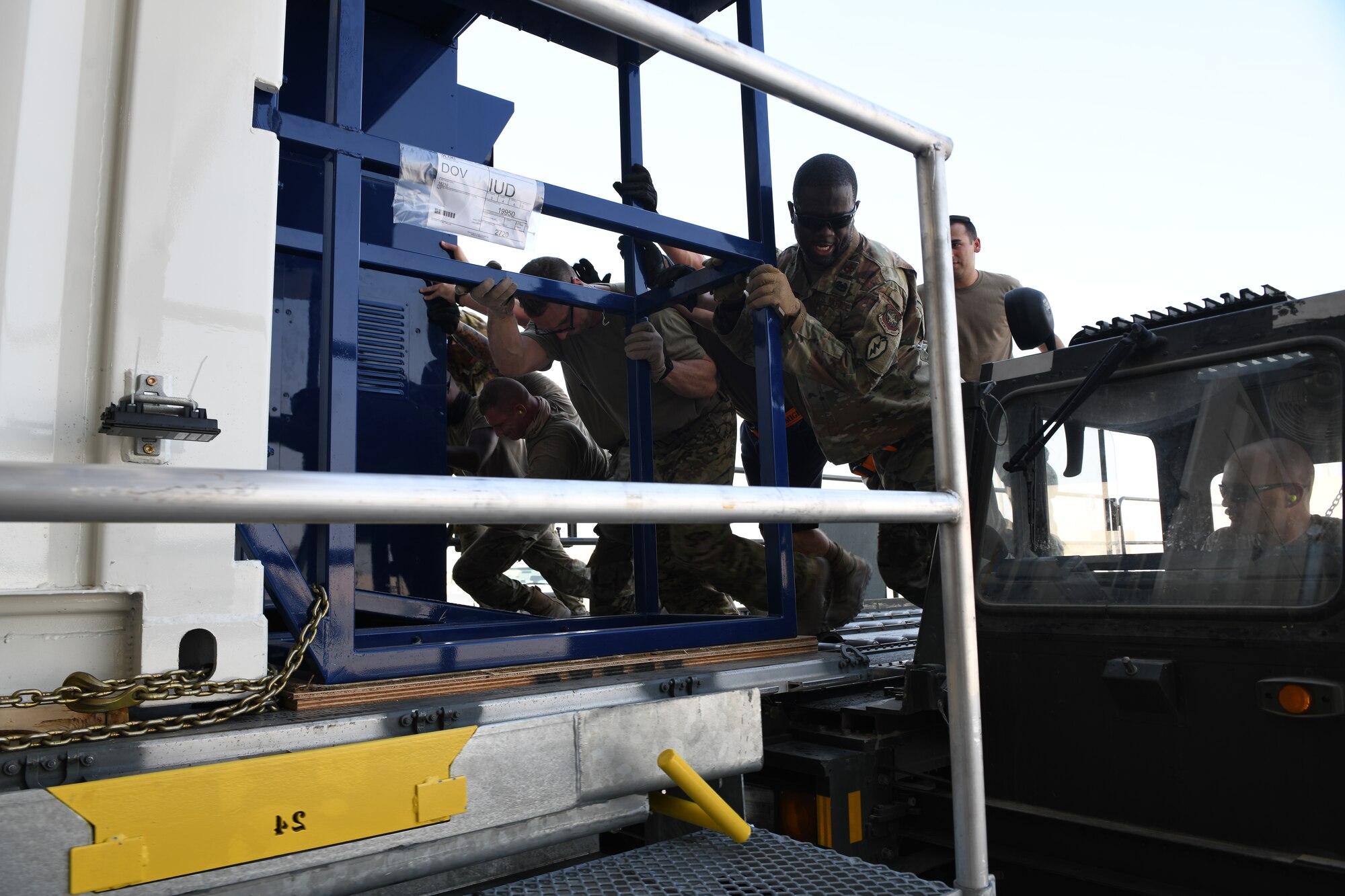 Airmen load a specialized medical container designed to transport individuals with infectious diseases into a clamshell hangar on the flight line of Al Udeid Air Base, Qatar,  Sept. 18, 2020. The Negatively Pressurized Conex, or NPC, is configured for the C-17 Globemaster III and C-5 Super Galaxy aircraft to safely transport up to 28 passengers or 23 patients, including ambulatory and litter, around the globe. (U.S. Air Force photo by Staff Sgt. Kayla White)