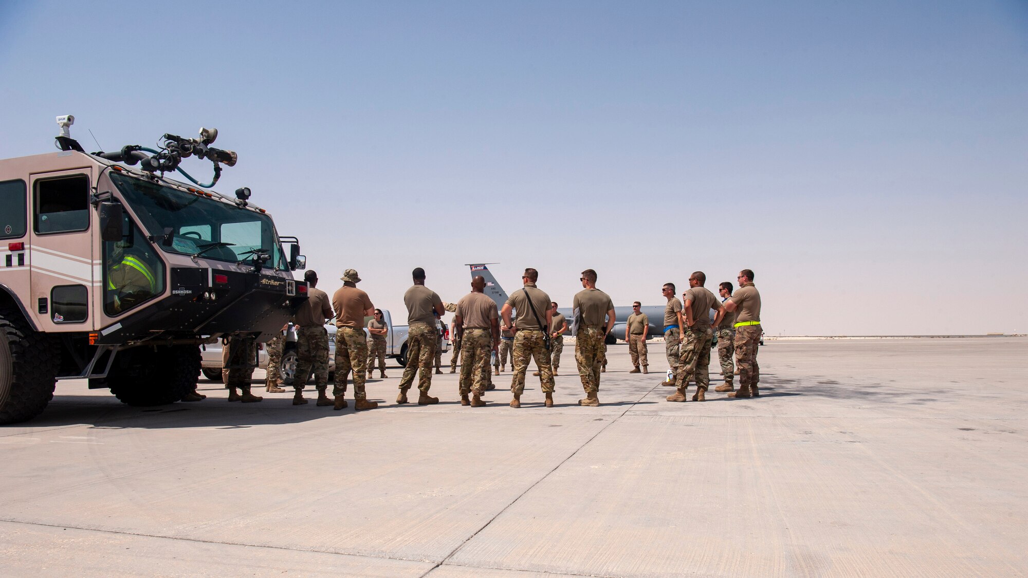 Members of the 379th Air Expeditionary Wing huddle before a KC-135 Stratotanker aircraft hot refueling training scenario for certification at Al Udeid Air Base, Qatar, Sept. 21, 2020. The training, the first for a KC-135, will enhance refueling mission capabilities and cut the refueling time in half.