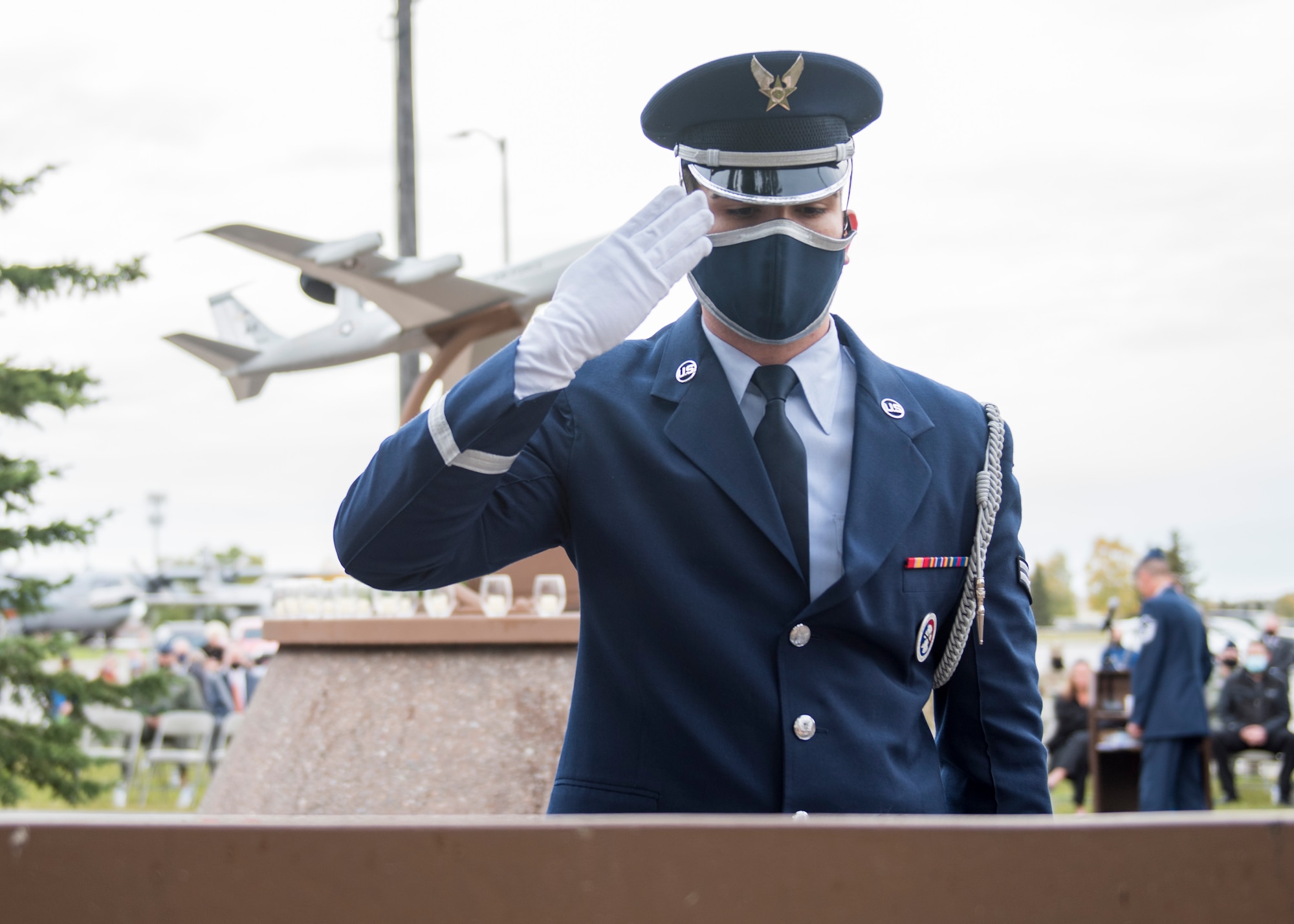 A U.S. Air Force Honor Guard member renders a salute in front of the individual memorial of one of the lost crew members at the Yukla 27 25th anniversary memorial ceremony at Joint Base Elmendorf-Richardson, Alaska, Sept. 22, 2020. Yukla 27, a U.S. Air Force E-3 Sentry airborne warning and control system aircraft assigned to the 962nd AACS, encountered a flock of geese Sept. 22, 1995, and crashed shortly after takeoff on a routine surveillance training sortie, killing all 24 Canadian and U.S. Airmen aboard.