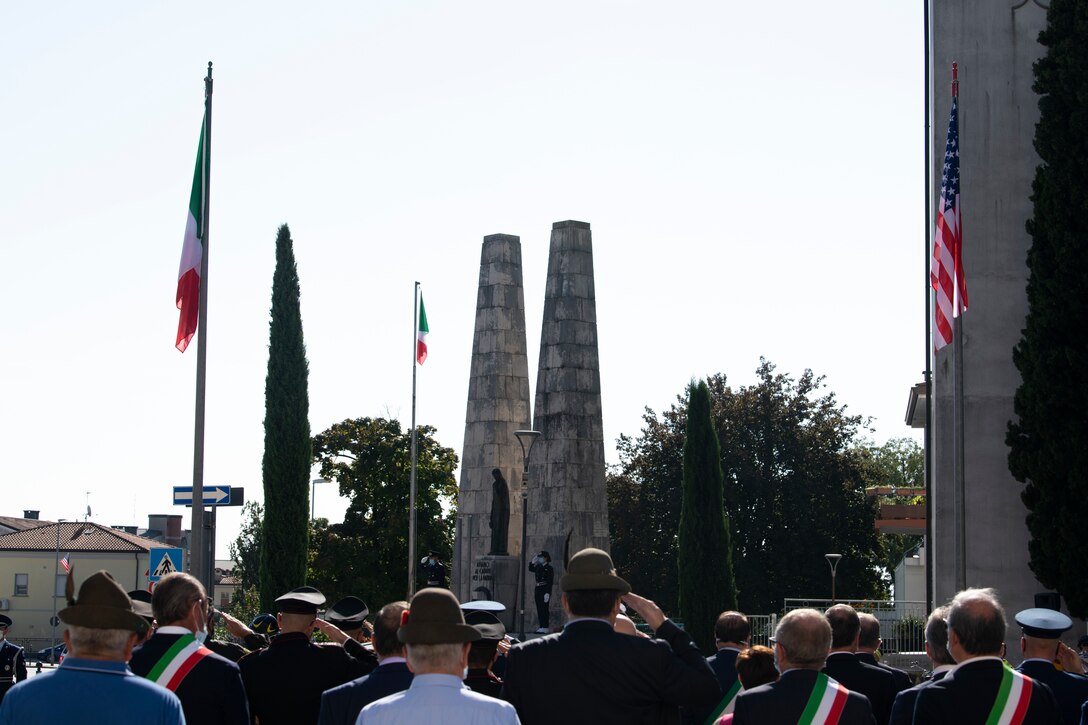 Attendees salute the Italian and American flags during the opening ceremony of the 19th Annual Italian-American Friendship Festival in Aviano, Italy, Sept. 12, 2020. The first festival was held in 2002 to honor the victims of 9/11. This year’s event also commemorated the COVID-19 victims. (U.S. Air Force photo by Senior Airman Caleb House)