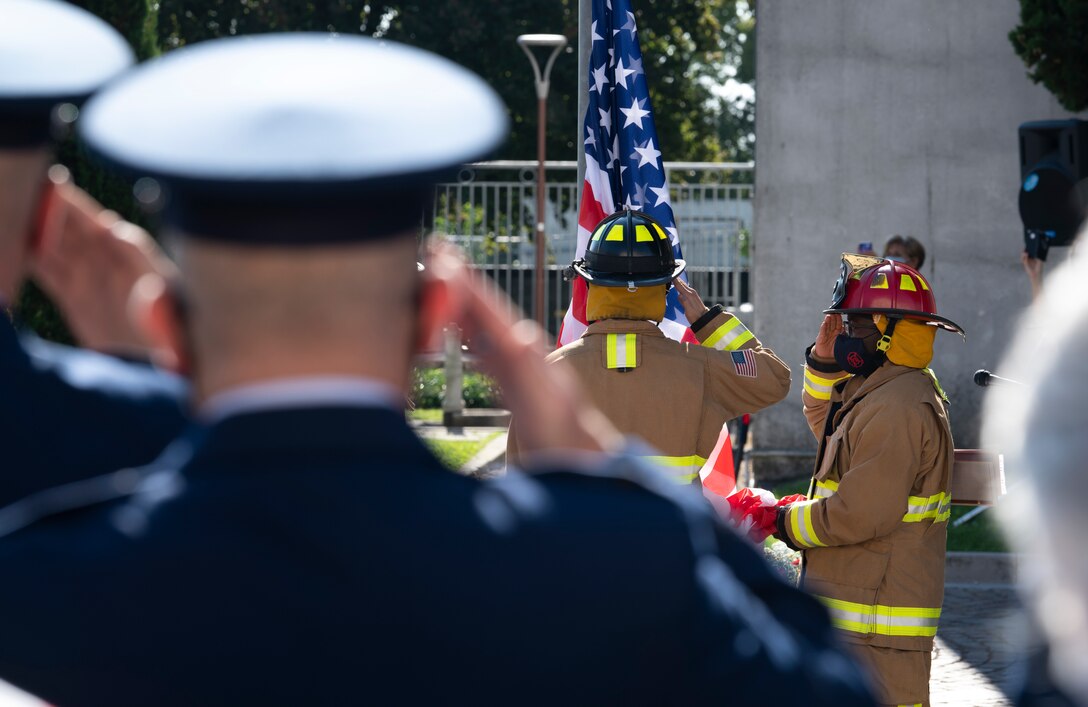 Airmen from the 31st Fighter Wing salute during the Italian national anthem in Aviano, Italy, Sept. 12, 2020. The Airmen attended the 19th Annual Italian-American Friendship Festival. The festival began in 2002 as a way to commemorate the anniversary of 9/11 and moves between municipalities in the region. (U.S. Air Force photo by Senior Airman Caleb House)