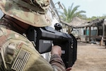 A Soldier with Bravo Company, 2nd Battalion, 135th Infantry Regiment, looks through the optic device of the Drone Defender V2 during Counter Unmanned Aircraft Systems training at Camp Lemonnier, Djibouti, Aug. 19, 2020. The Drone Defender V2 is an electronic warfare weapon capable of downing and disabling a small unmanned aircraft system, also known as a drone.