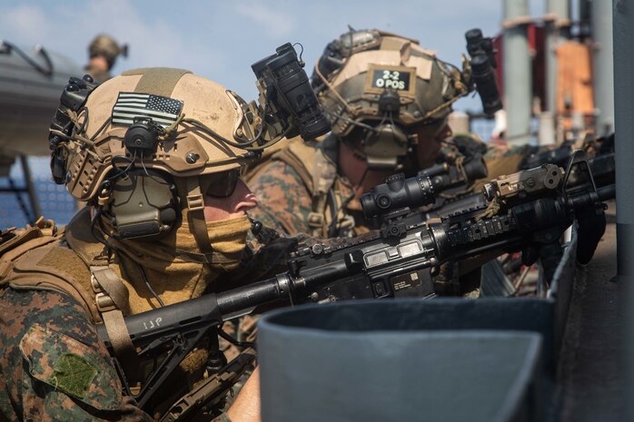 U.S. Marines provide security during a simulated visit, board, search, and seizure mission aboard dock landing ship USS Germantown (LSD 42), Sept. 6.