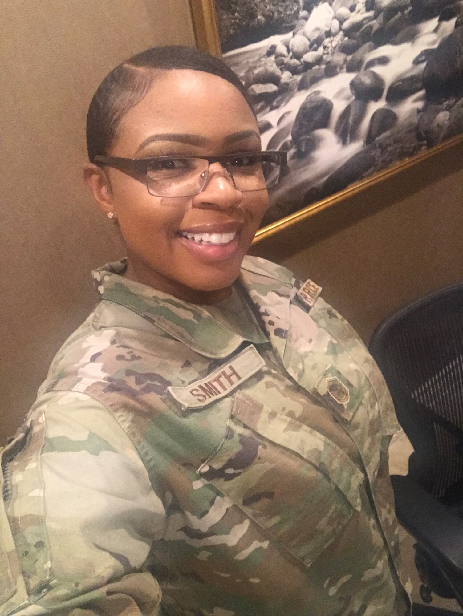 Woman in uniform poses for photo.